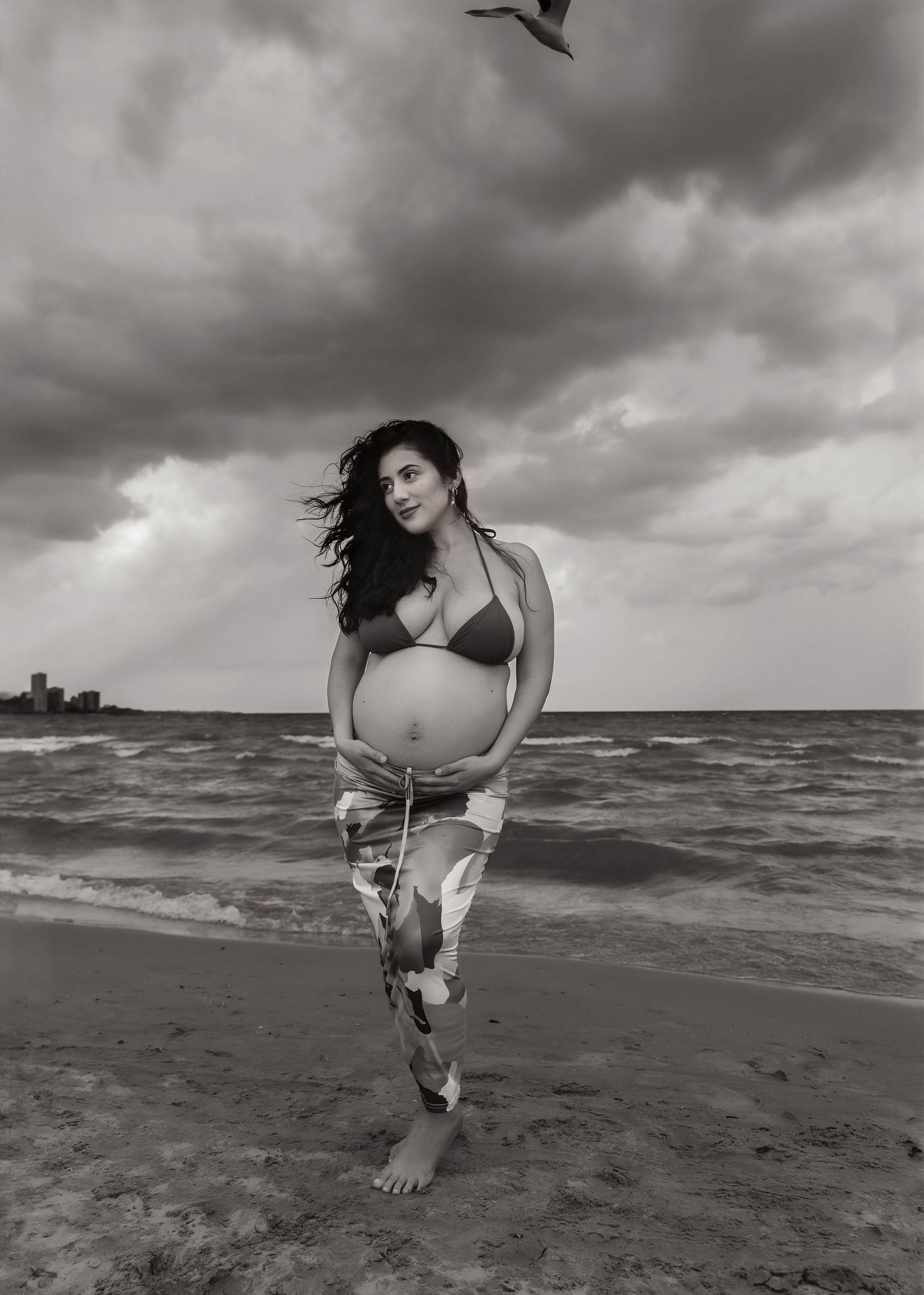 Beach Swim maternity session on overcast day on Montrose Beach in Chicago, IL