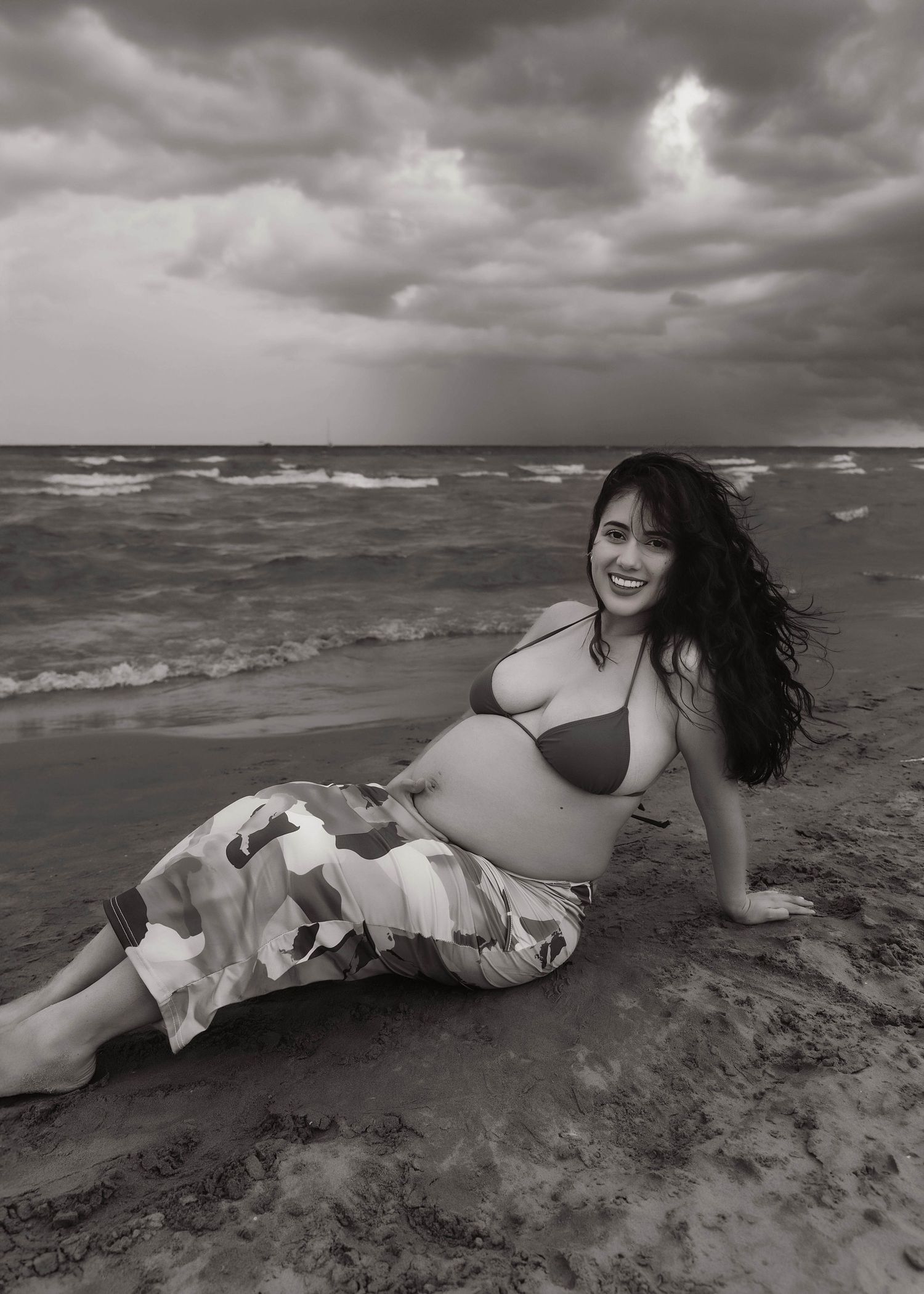Beach Swim maternity session on overcast day on Montrose Beach in Chicago, IL