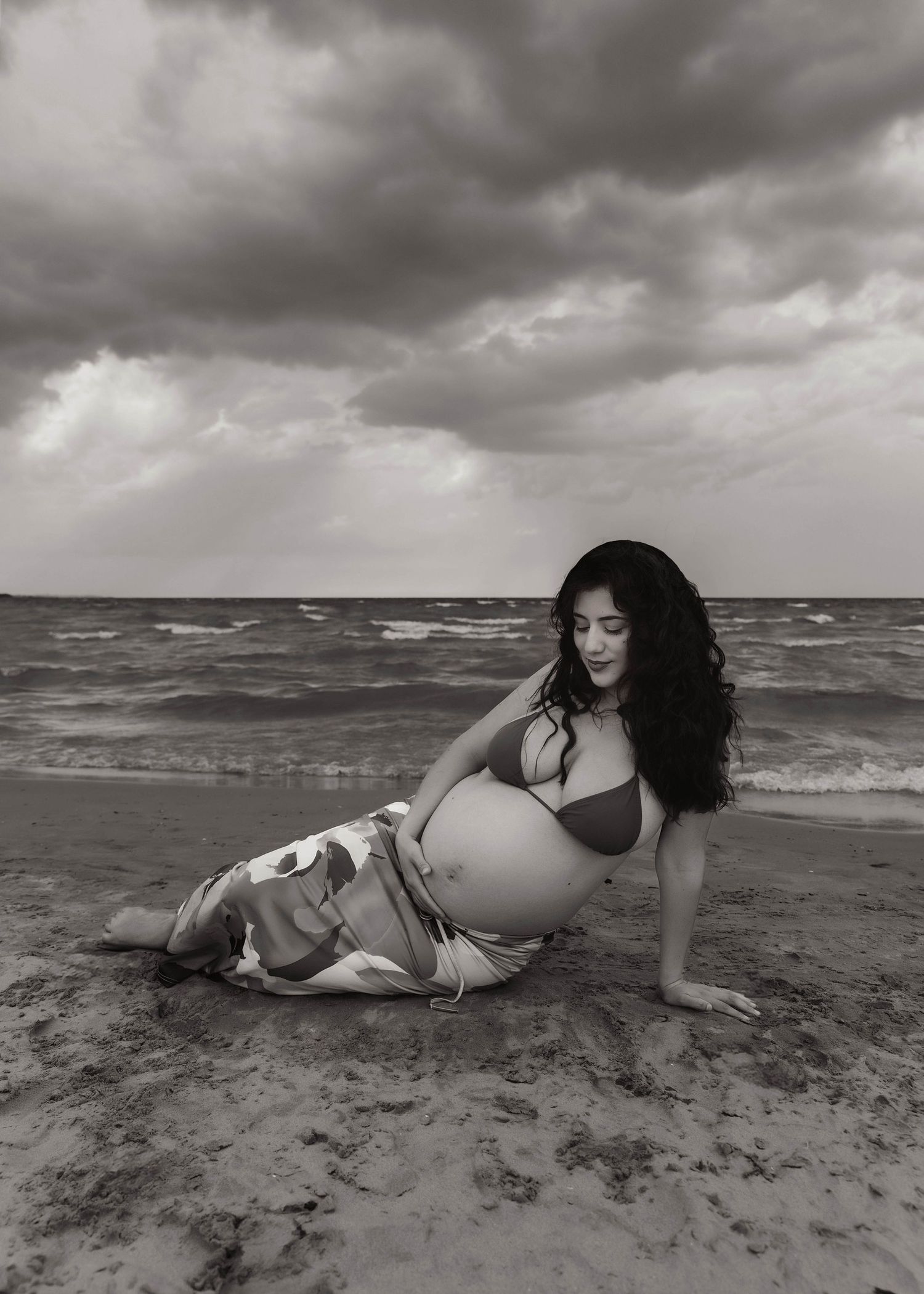 Beach Swim maternity session on overcast day on Montrose Beach in Chicago, IL