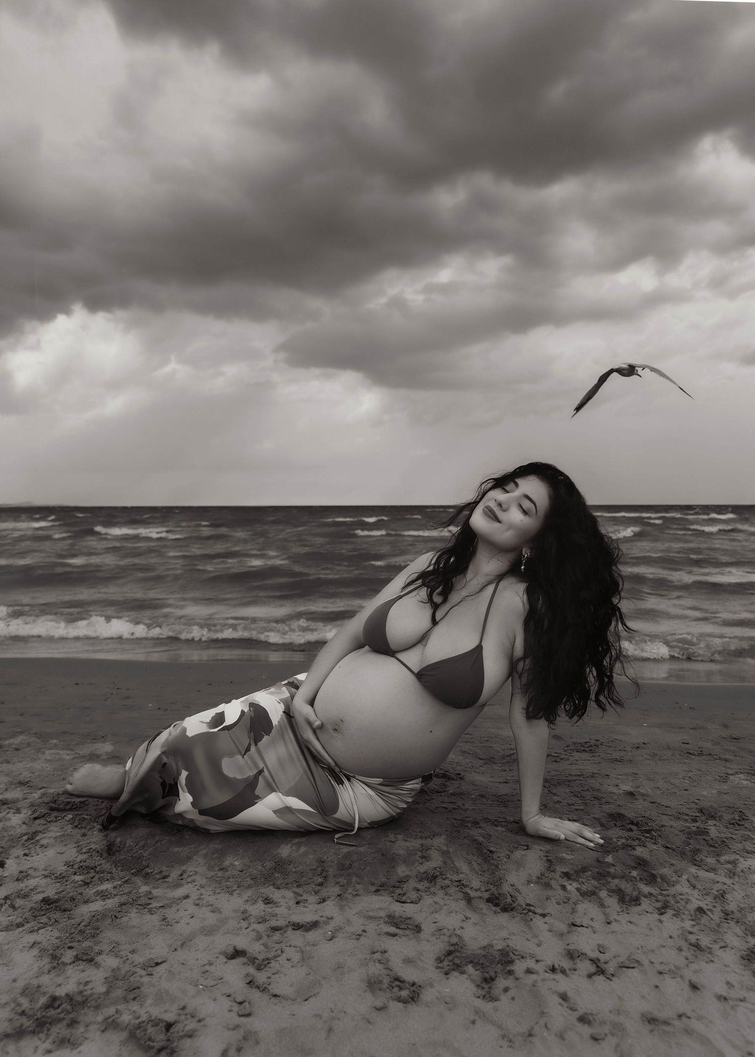Beach Swim maternity session on overcast day on Montrose Beach in Chicago, IL