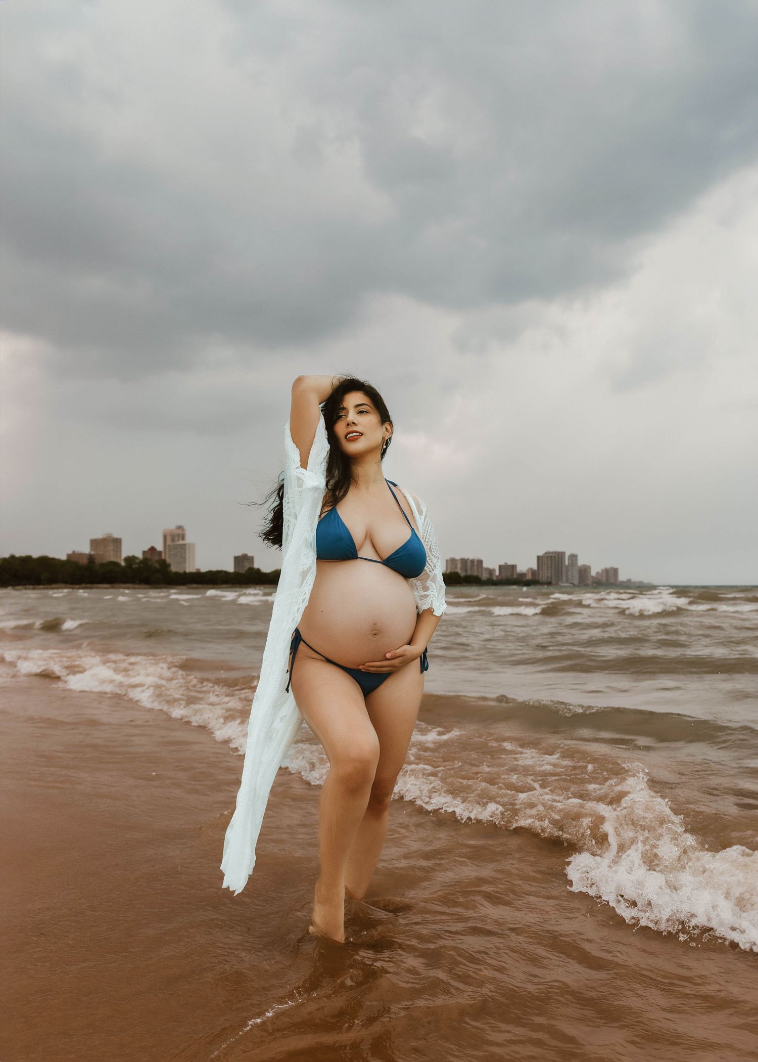 Beach Swim maternity session on overcast day on Montrose Beach in Chicago, IL