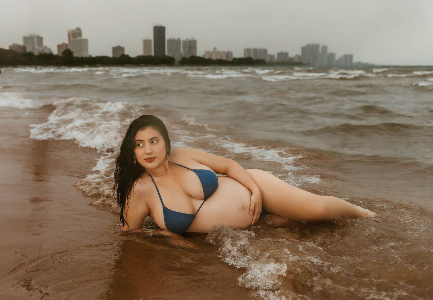 Beach Swim maternity session on overcast day on Montrose Beach in Chicago, IL