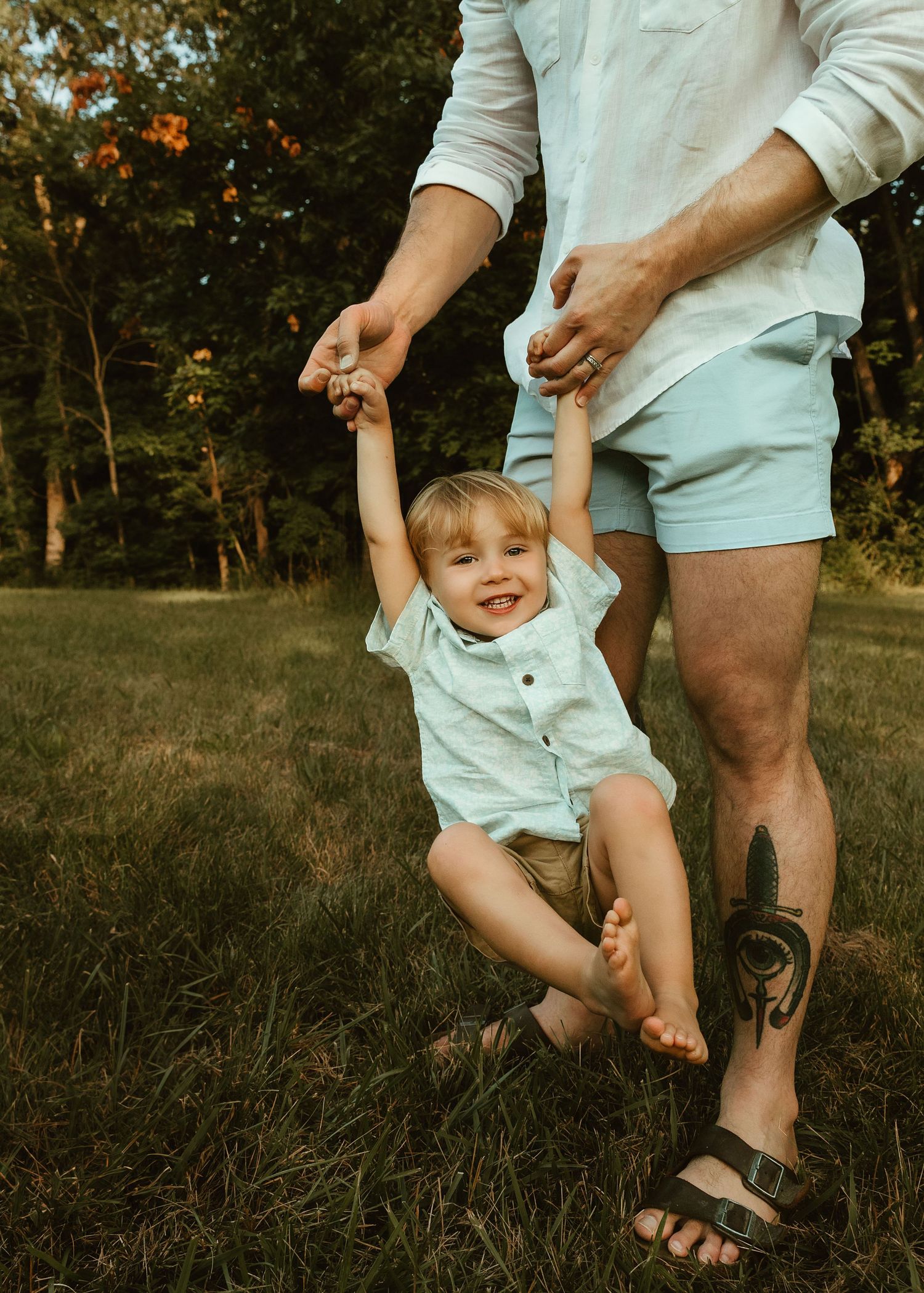 Playful family session of dad and son, lifestyle family session in Washington, IL at the Farmdale Resevior