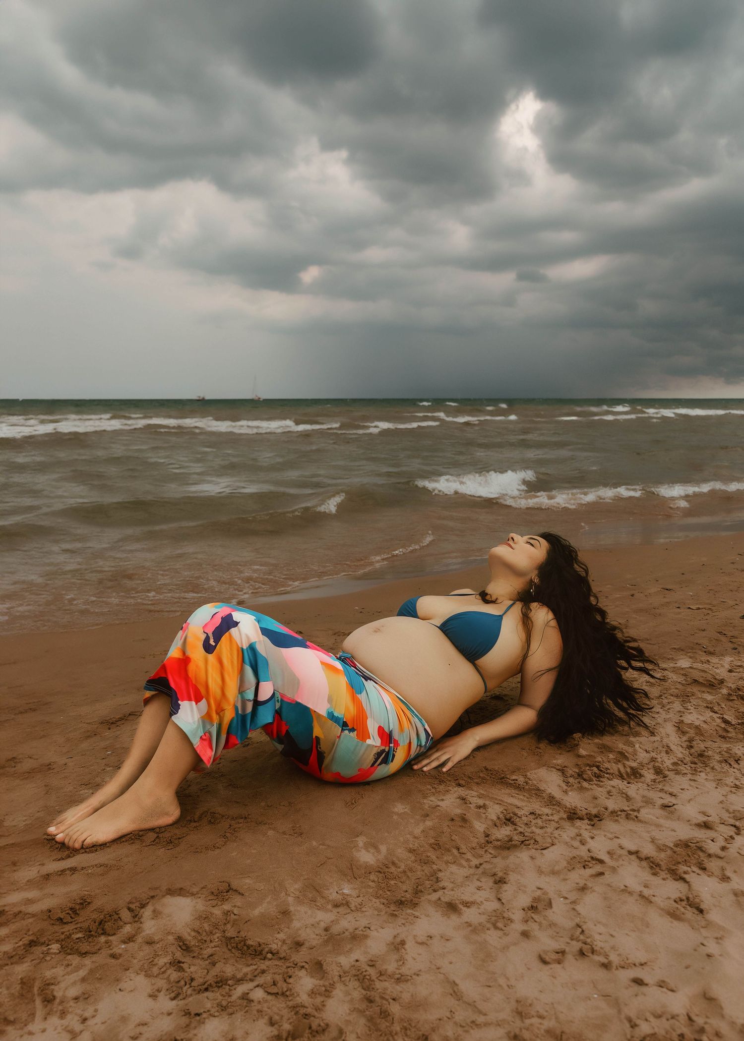 Beach Swim maternity session on overcast day on Montrose Beach in Chicago, IL