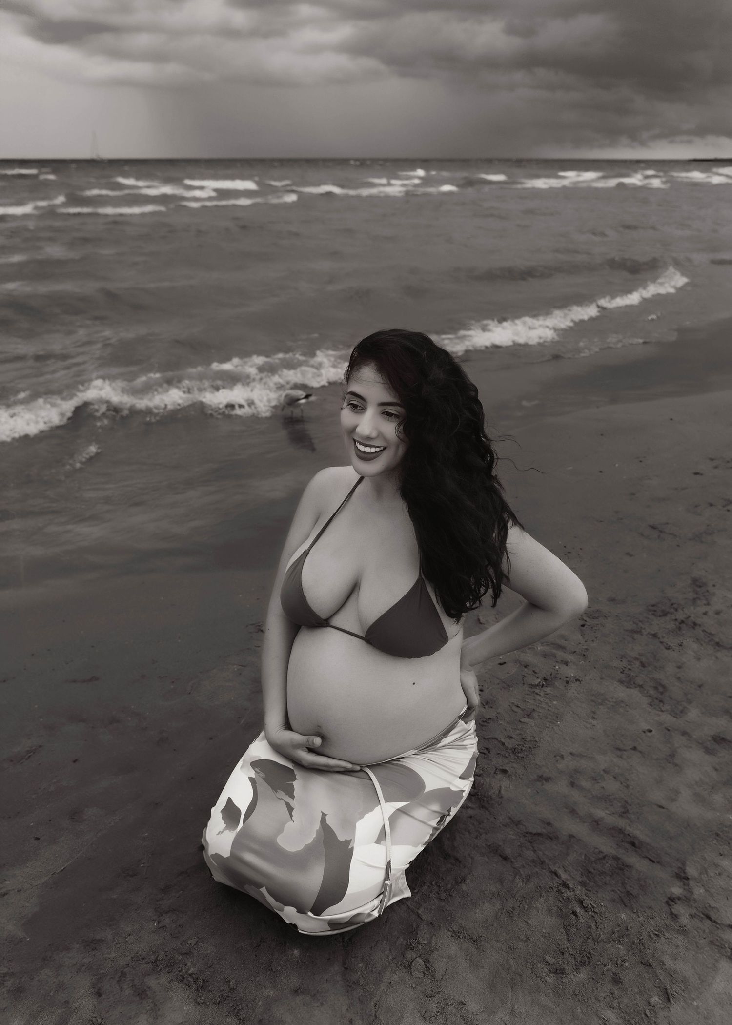 Beach Swim maternity session on overcast day on Montrose Beach in Chicago, IL