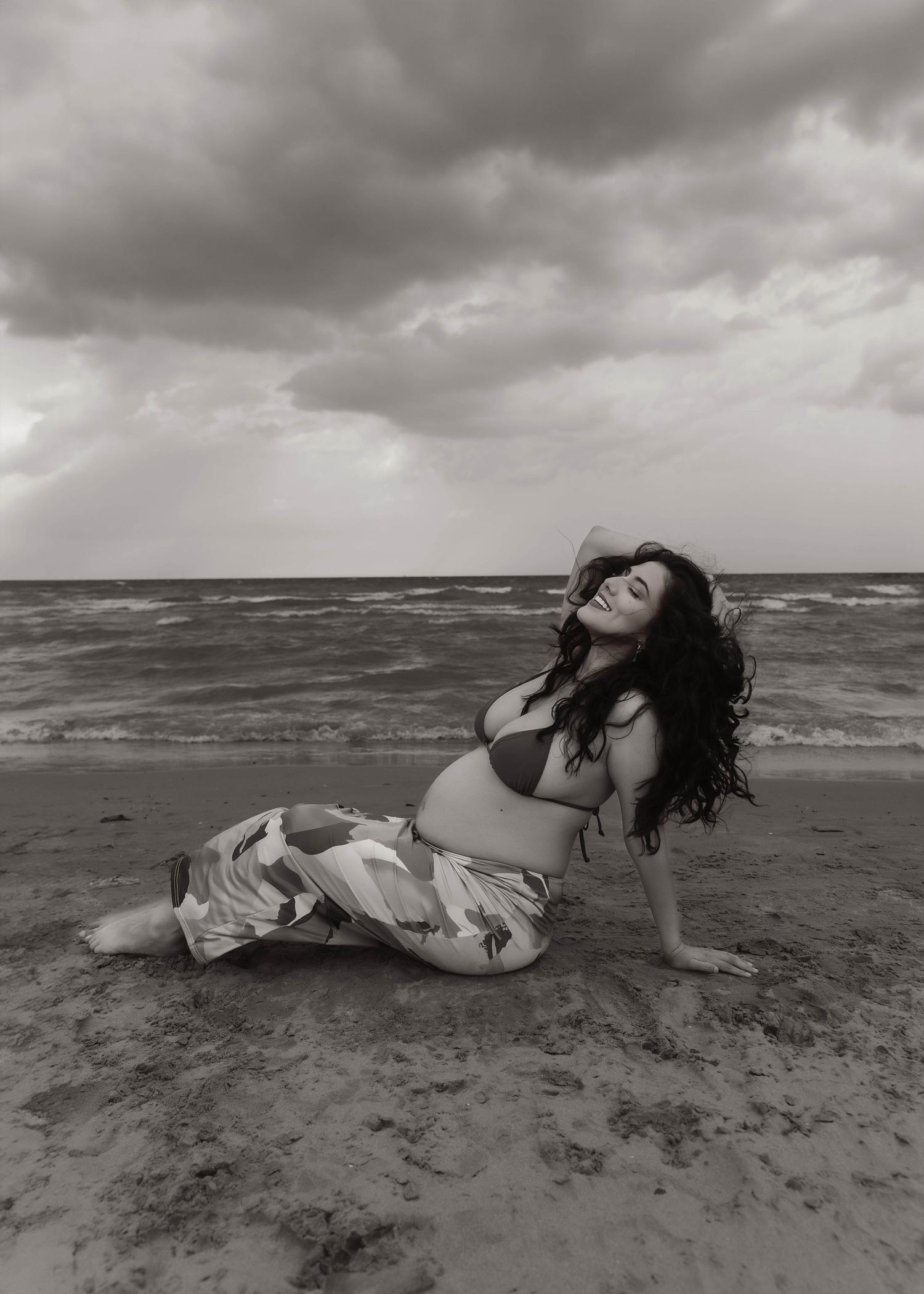 Beach Swim maternity session on overcast day on Montrose Beach in Chicago, IL