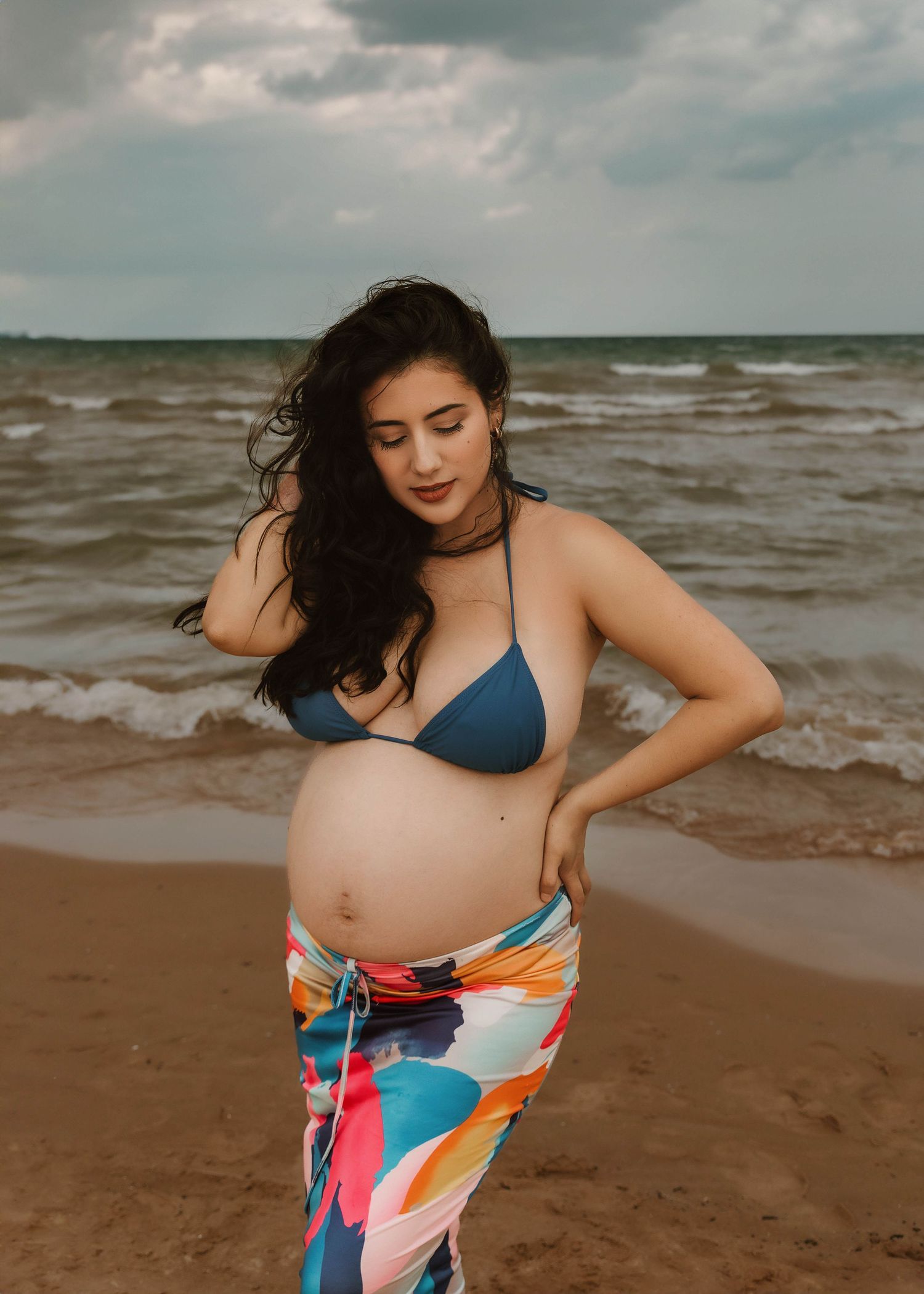 Beach Swim maternity session on overcast day on Montrose Beach in Chicago, IL