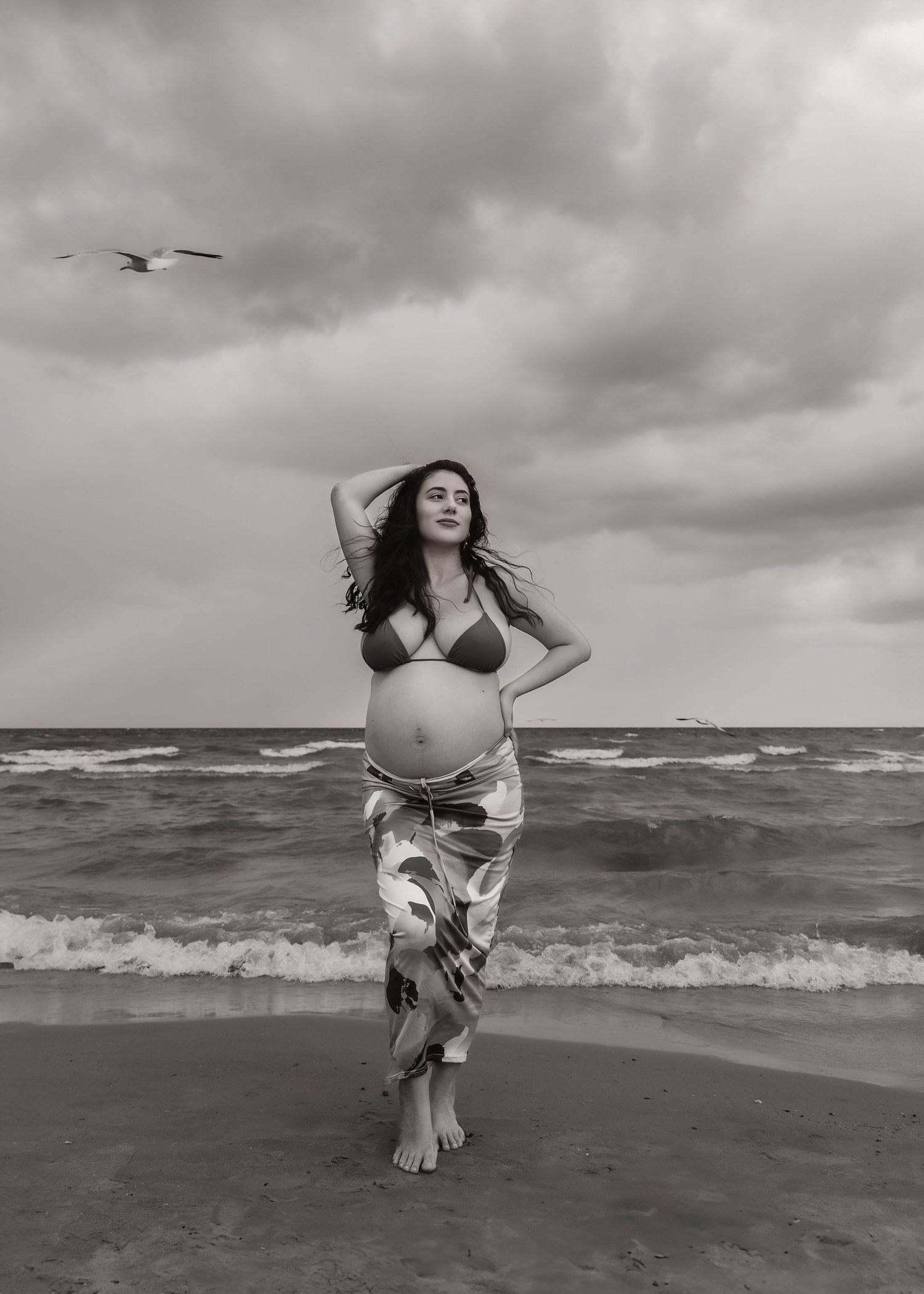 Beach Swim maternity session on overcast day on Montrose Beach in Chicago, IL