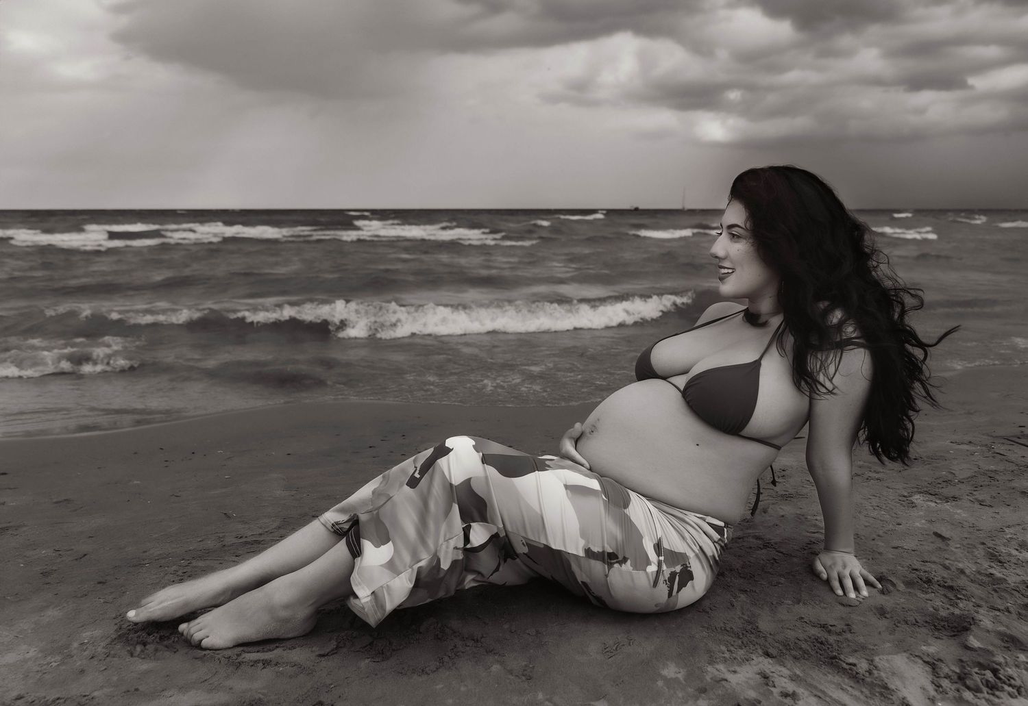 Beach Swim maternity session on overcast day on Montrose Beach in Chicago, IL
