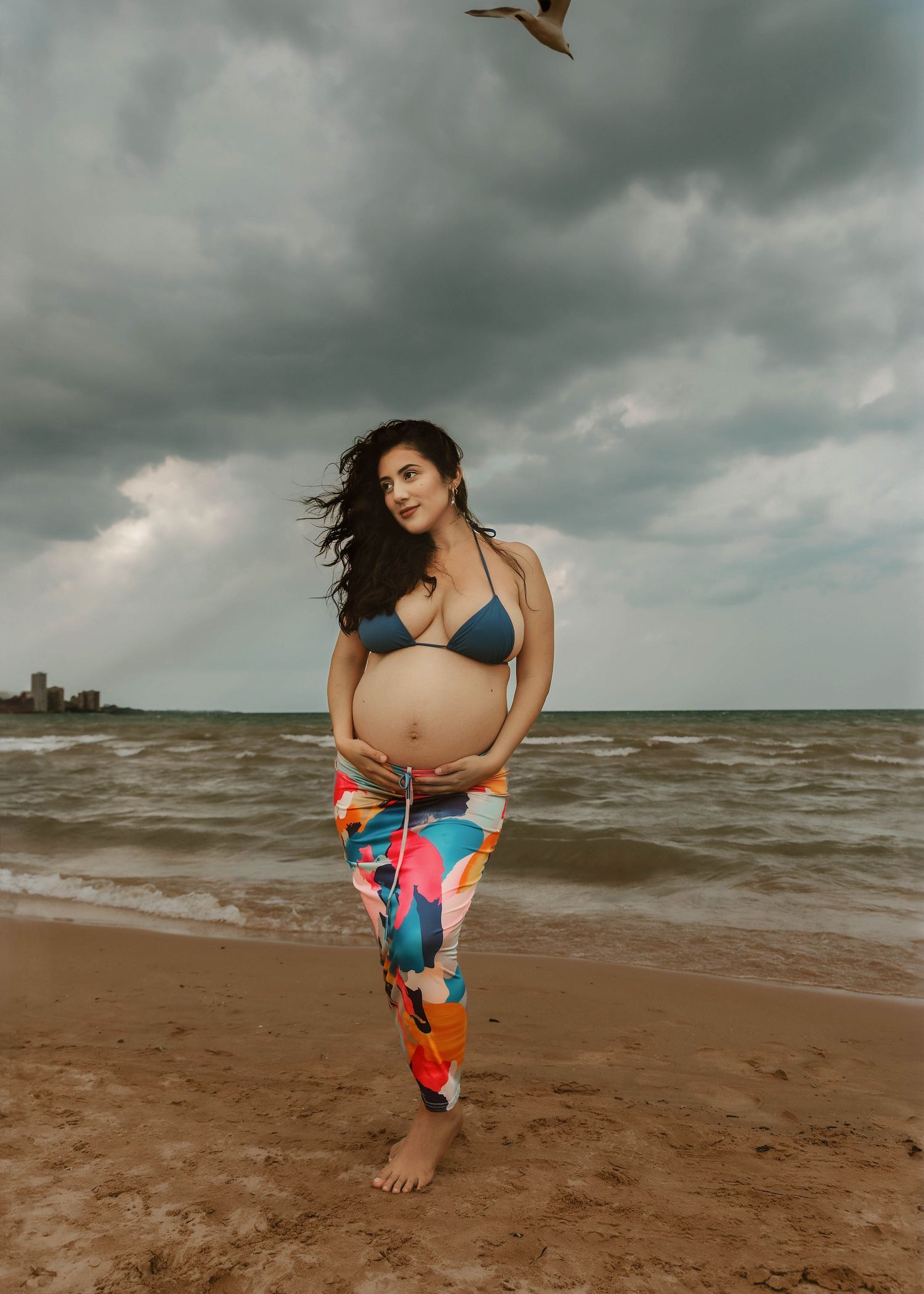 Beach Swim maternity session on overcast day on Montrose Beach in Chicago, IL