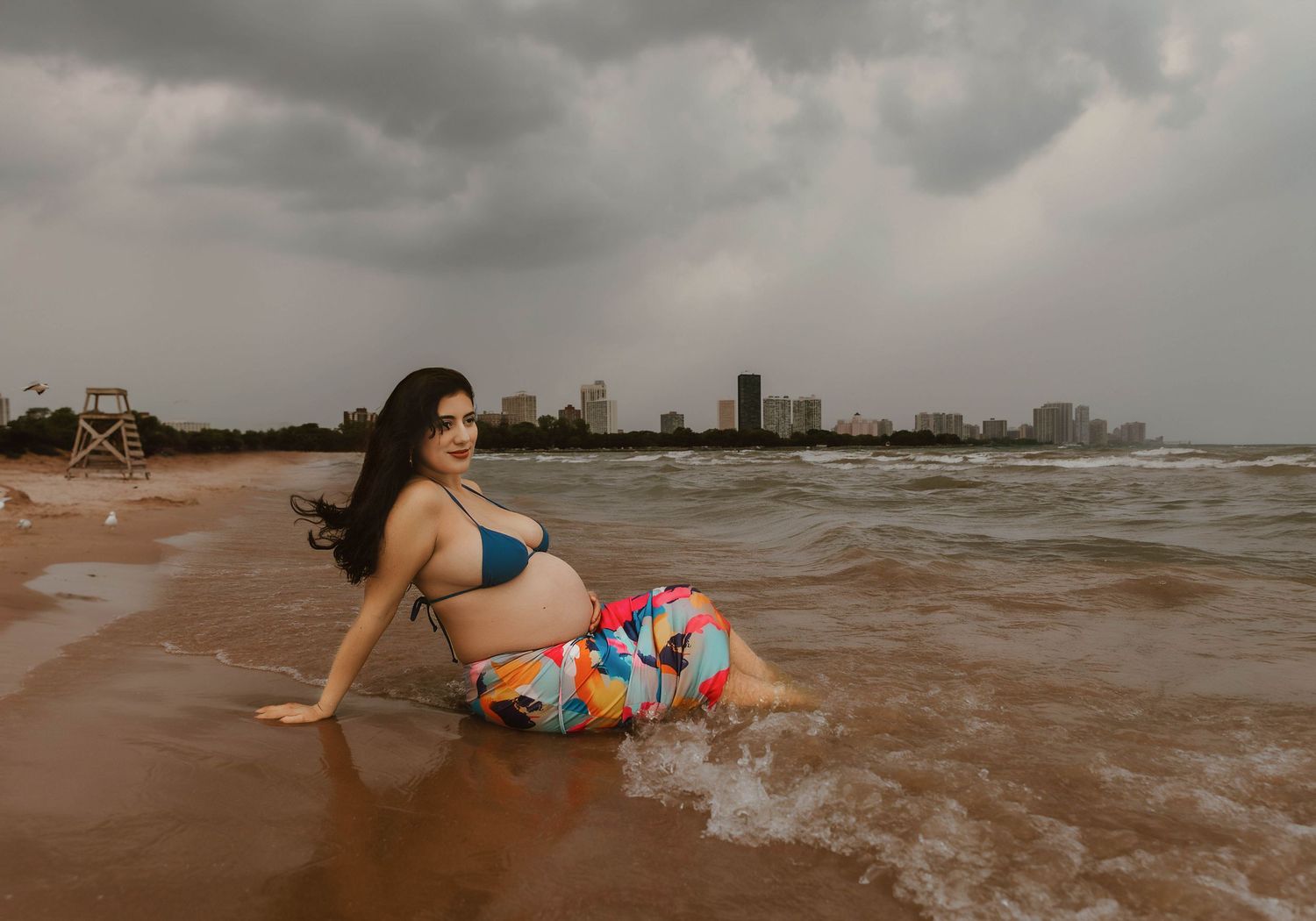 Beach Swim maternity session on overcast day on Montrose Beach in Chicago, IL