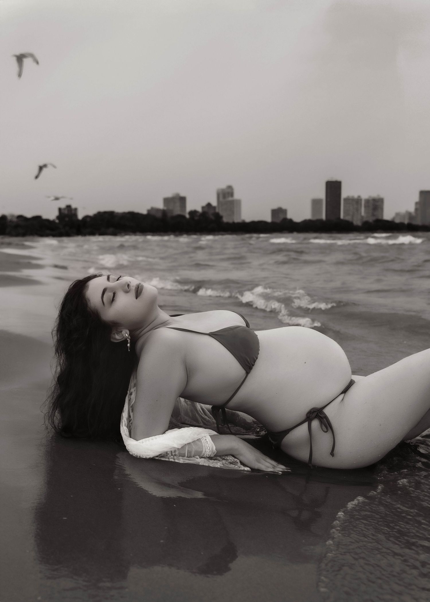 Beach Swim maternity session on overcast day on Montrose Beach in Chicago, IL