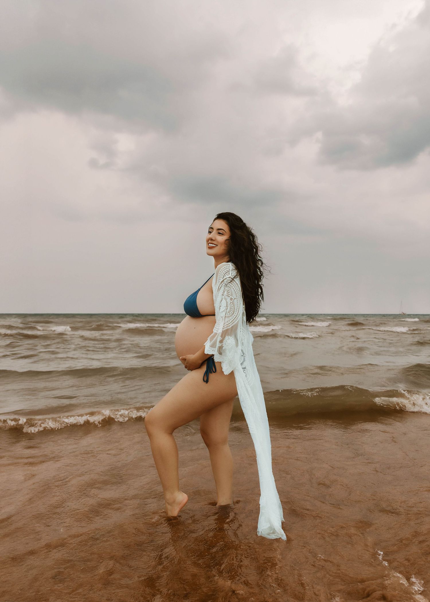 Beach Swim maternity session on overcast day on Montrose Beach in Chicago, IL