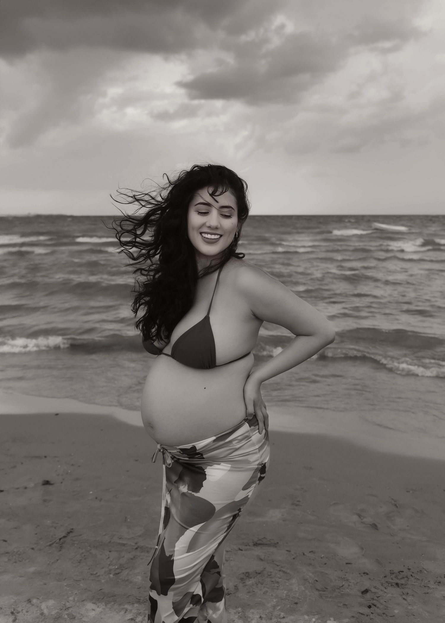 Beach Swim maternity session on overcast day on Montrose Beach in Chicago, IL