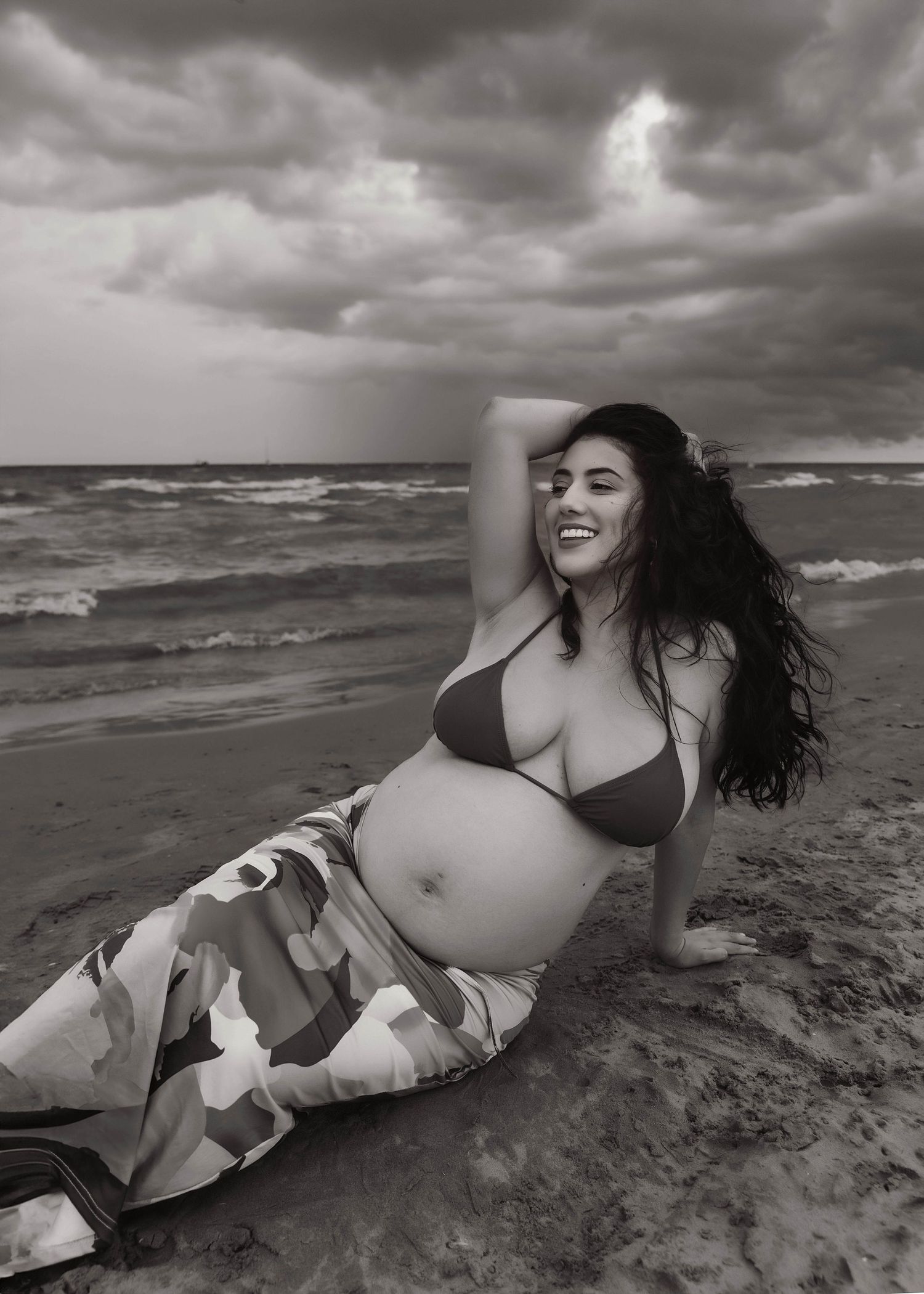 Beach Swim maternity session on overcast day on Montrose Beach in Chicago, IL