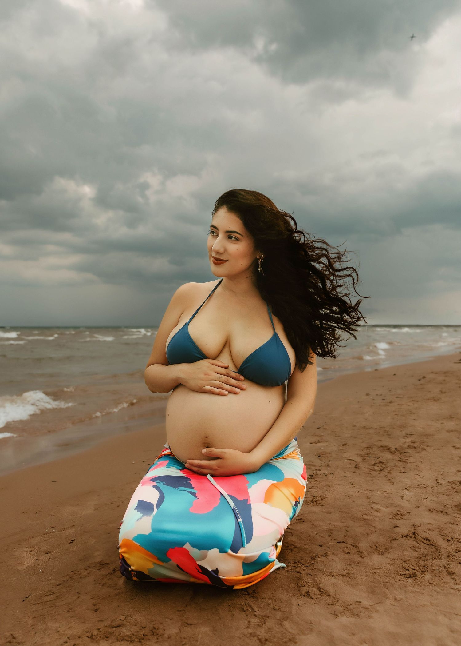 Beach Swim maternity session on overcast day on Montrose Beach in Chicago, IL