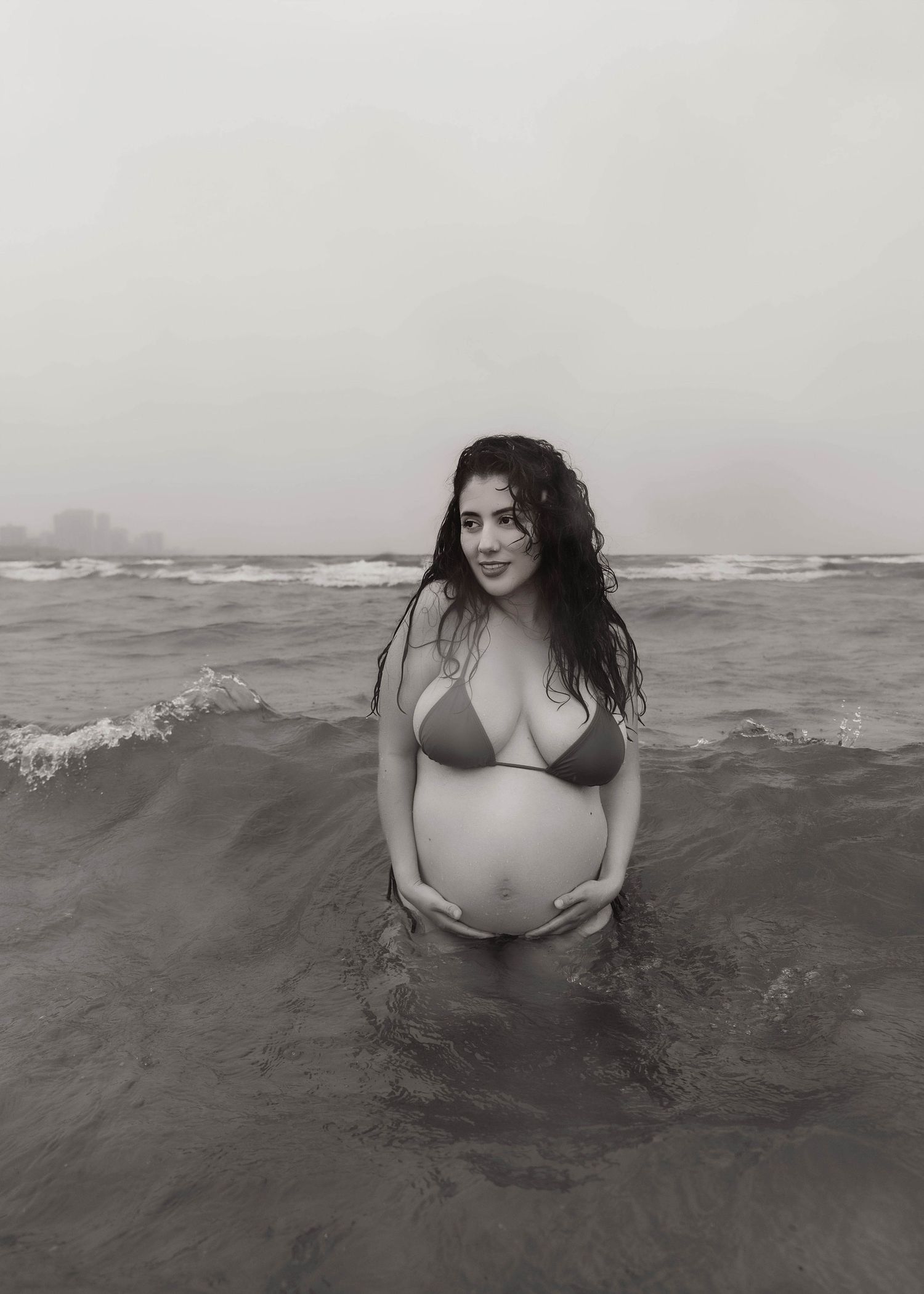 Beach Swim maternity session on overcast day on Montrose Beach in Chicago, IL