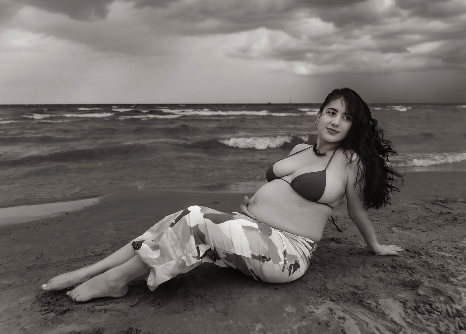 Beach Swim maternity session on overcast day on Montrose Beach in Chicago, IL