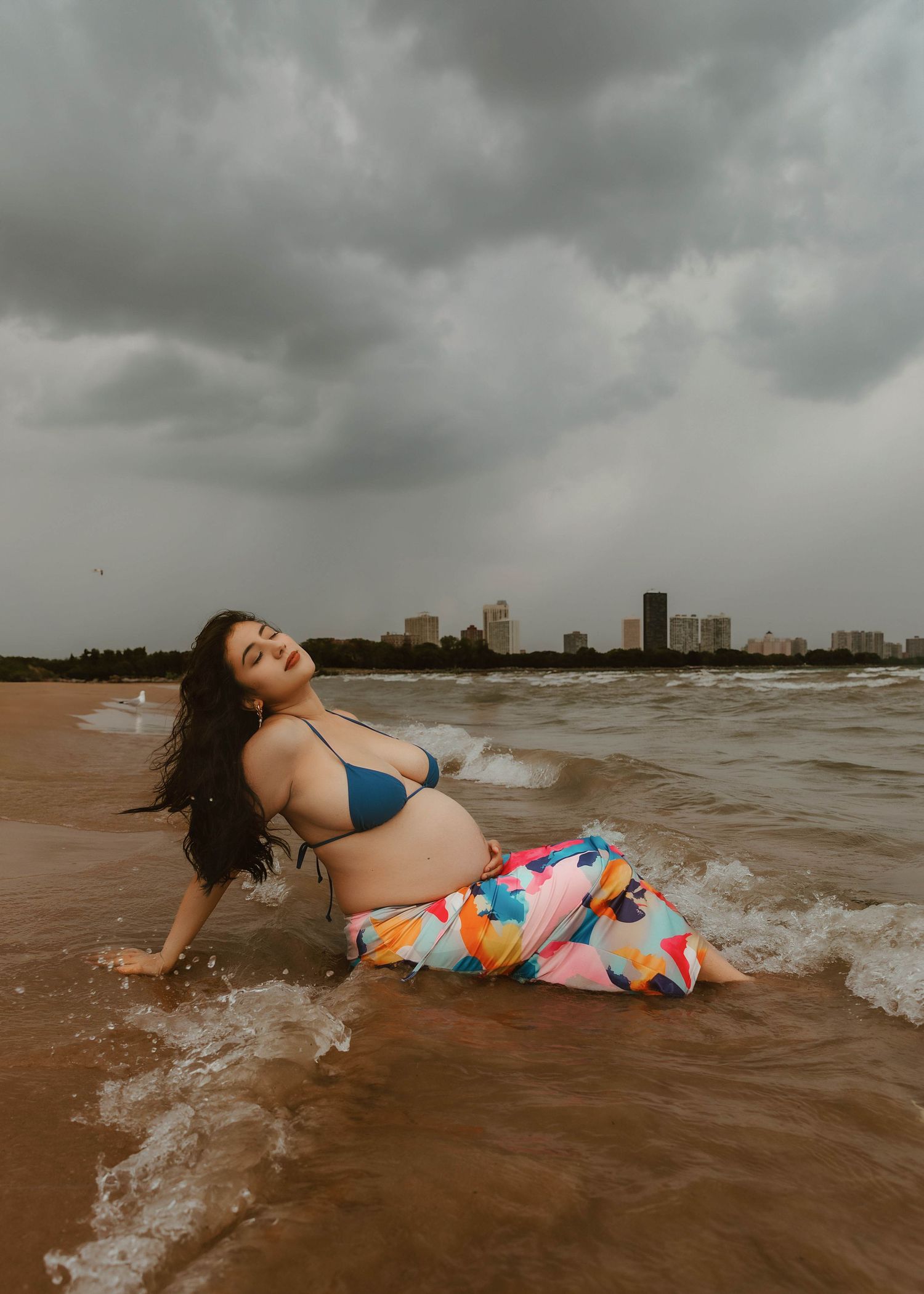 Beach Swim maternity session on overcast day on Montrose Beach in Chicago, IL