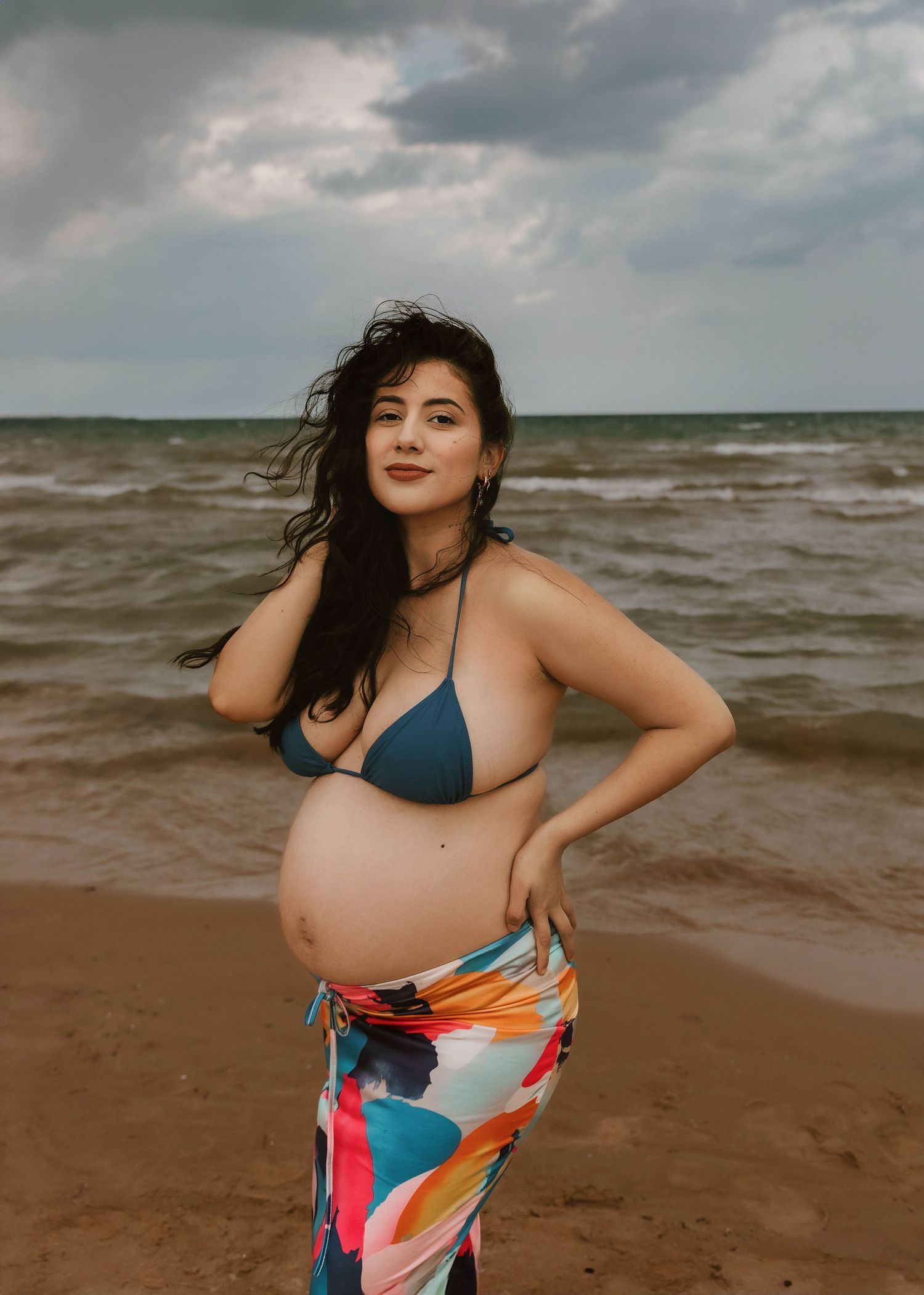 Beach Swim maternity session on overcast day on Montrose Beach in Chicago, IL