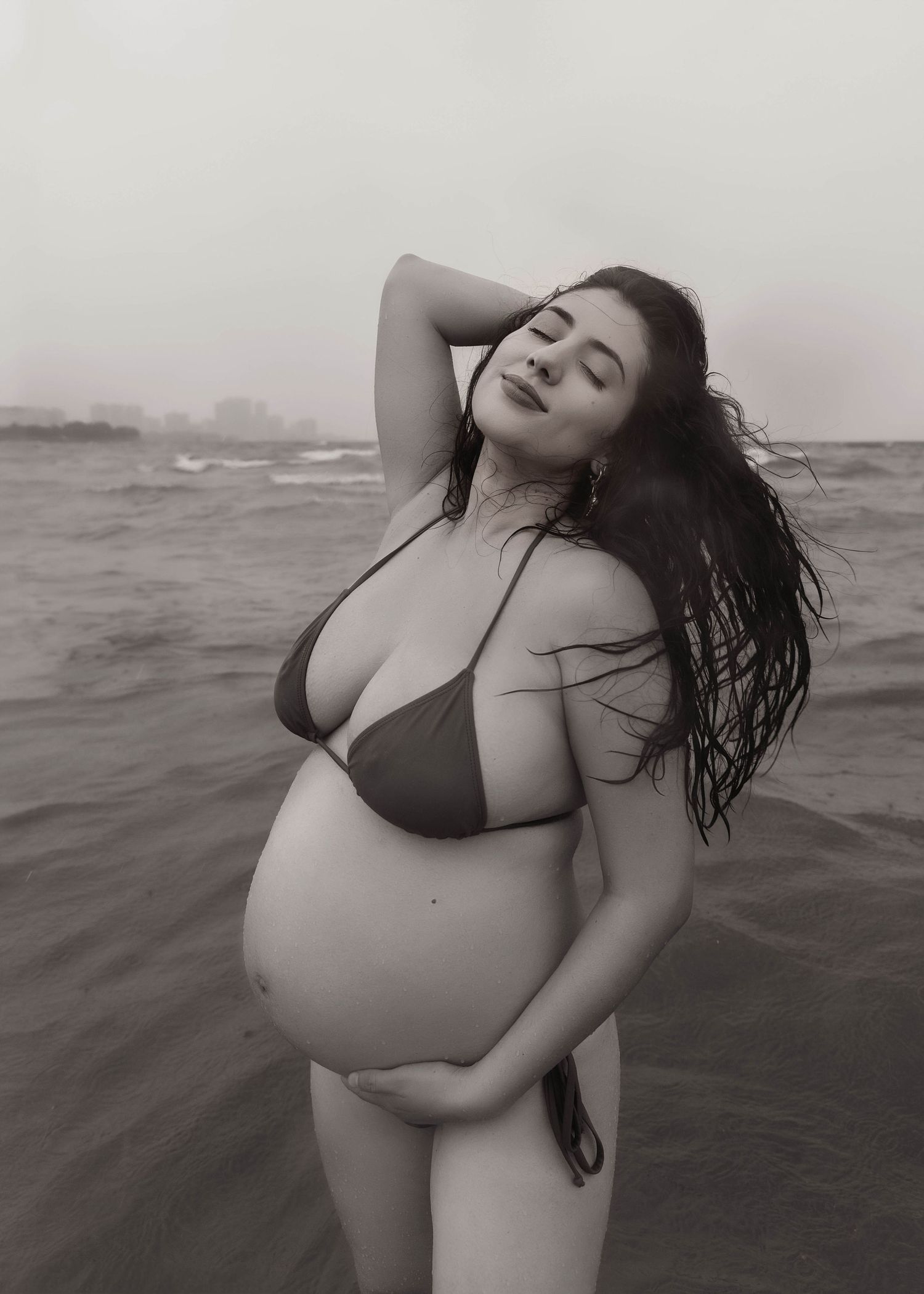 Beach Swim maternity session on overcast day on Montrose Beach in Chicago, IL
