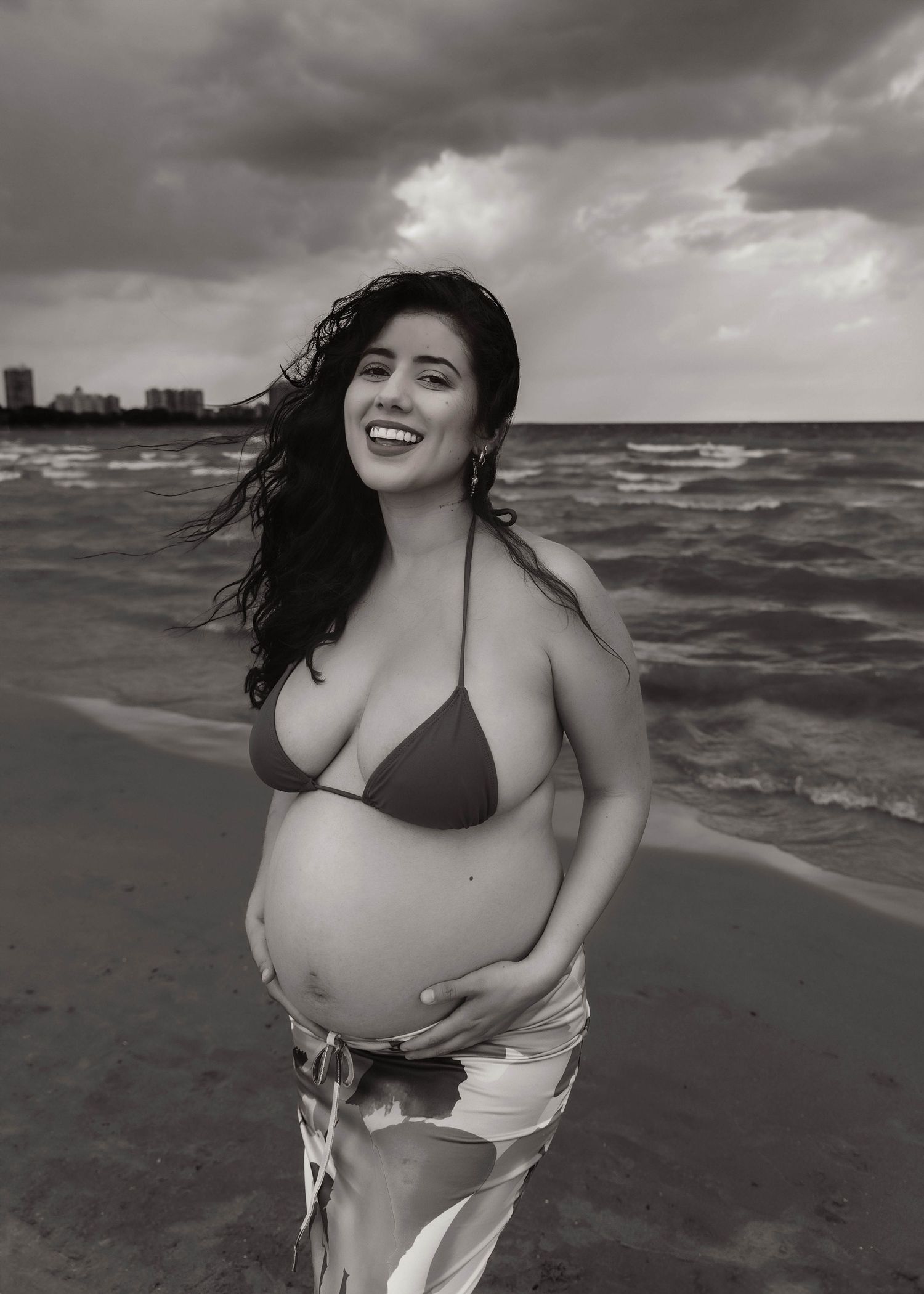 Beach Swim maternity session on overcast day on Montrose Beach in Chicago, IL
