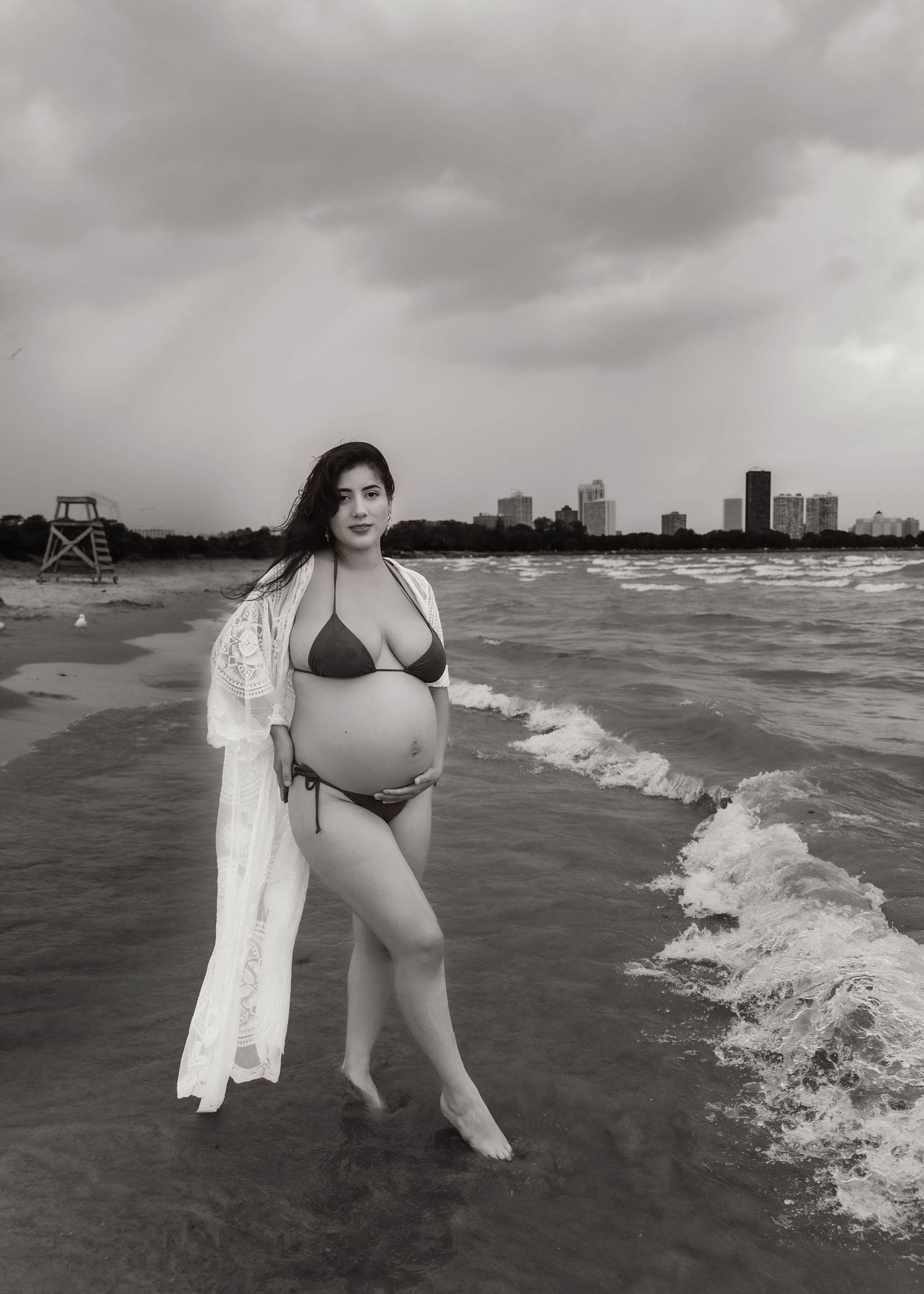 Beach Swim maternity session on overcast day on Montrose Beach in Chicago, IL