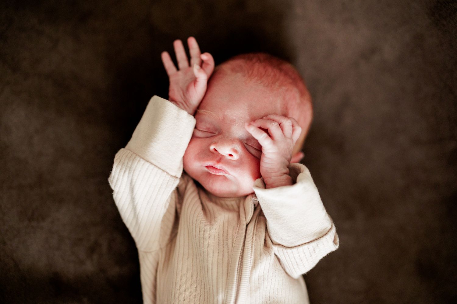 A newborn baby sleeping peacefully, wrapped in a soft blanket.