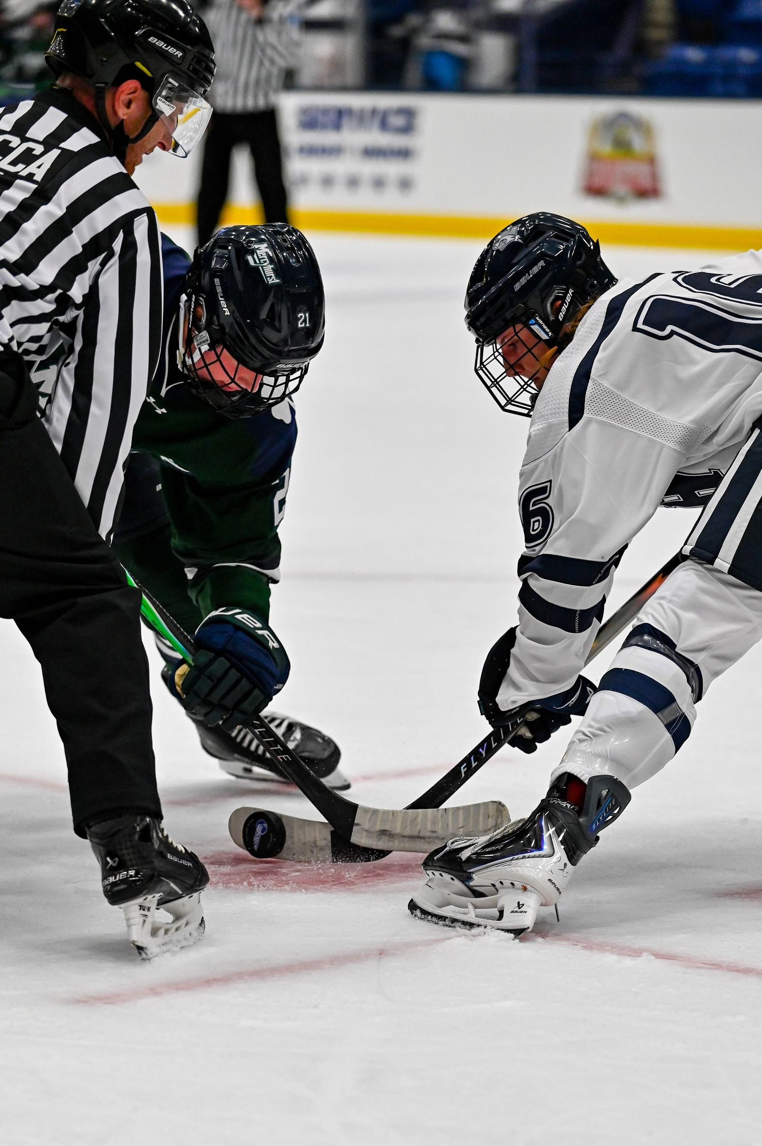 Close-up sequence of ice hockey players battling for the puck during an intense game.