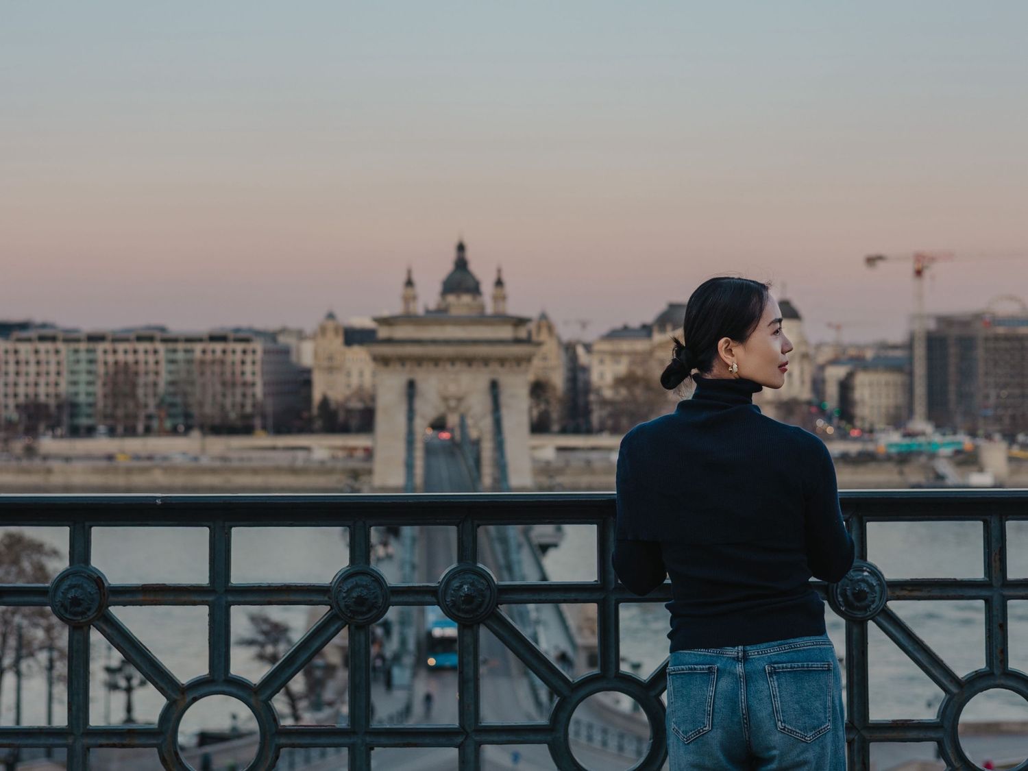 girl's portrait at Buda Castle looking at chain bridge and sunset