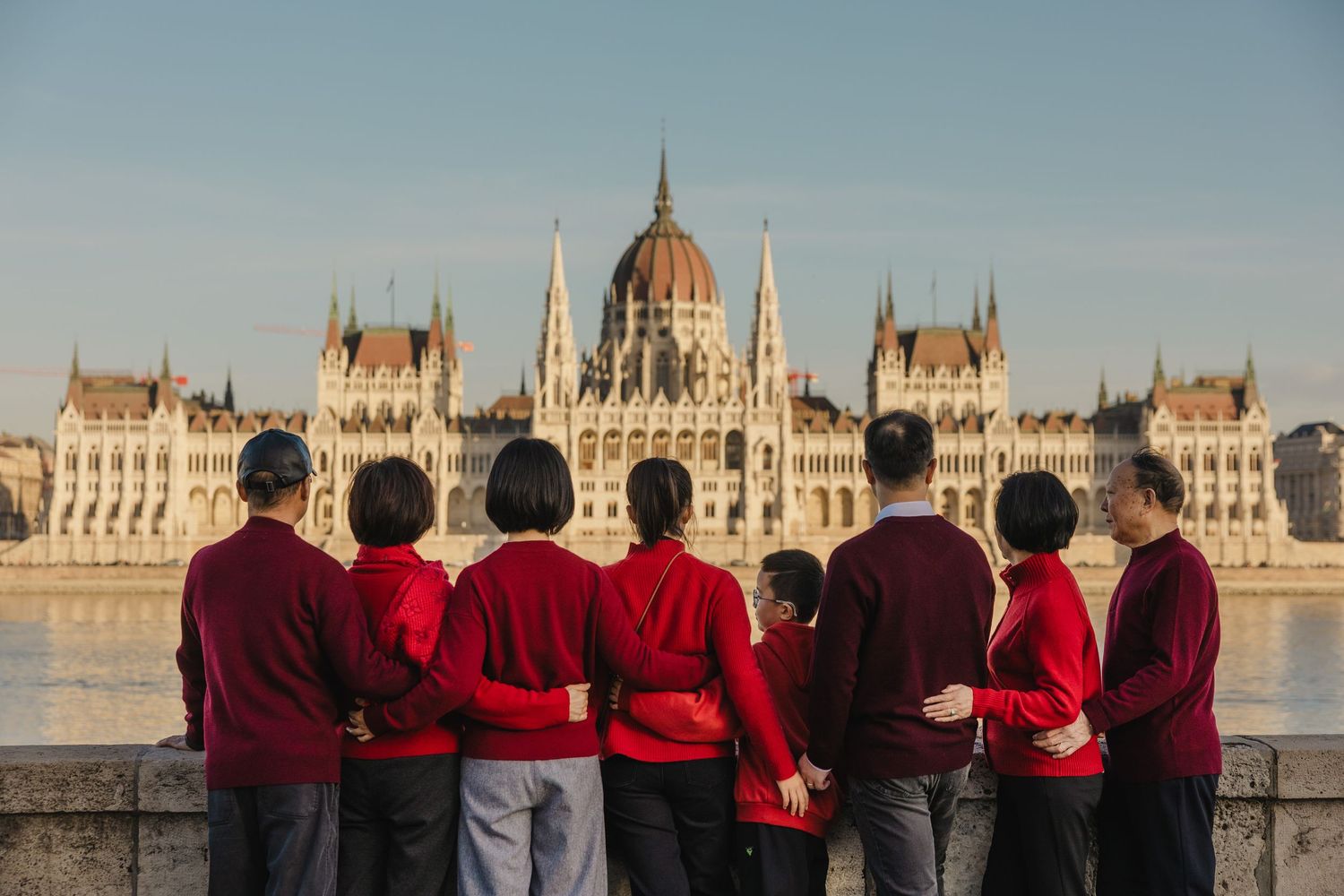 family photo at the Danube facing the Hungarian Parliament