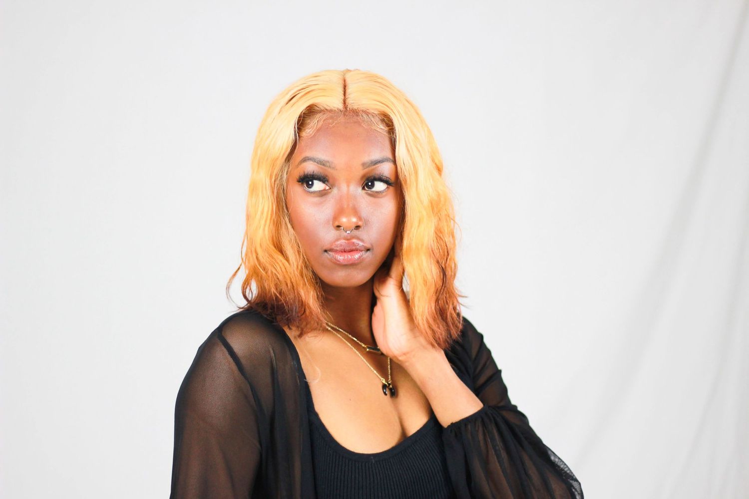 Studio portraits of woman with blonde hair against white background in various poses.