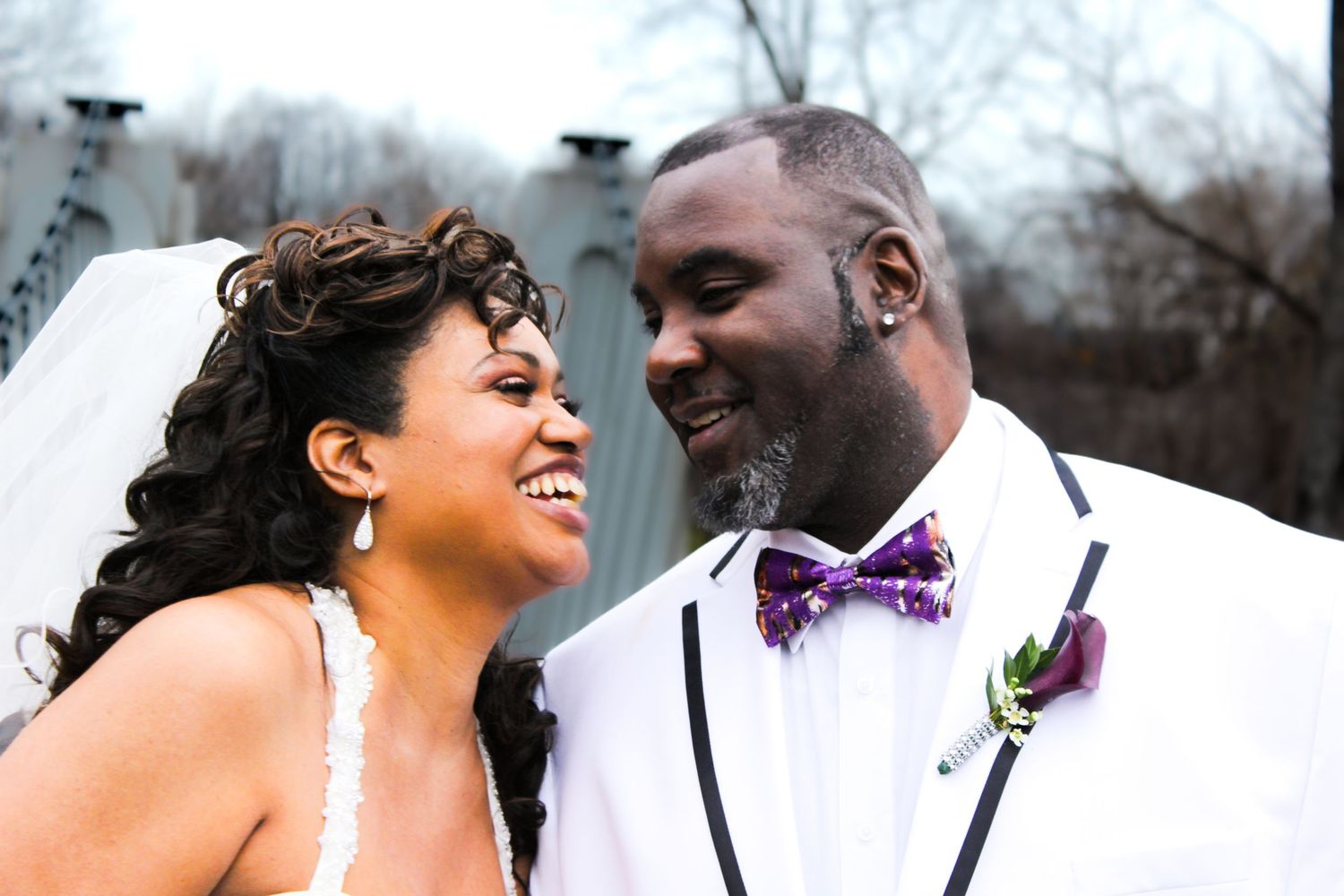 Bride and groom share romantic moments during their winter wedding photo session.