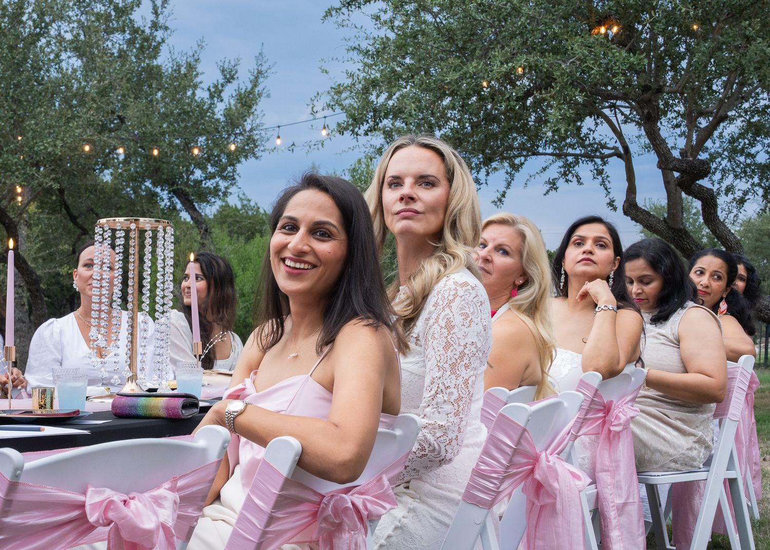 Women laughing and talking together at an outdoor celebration