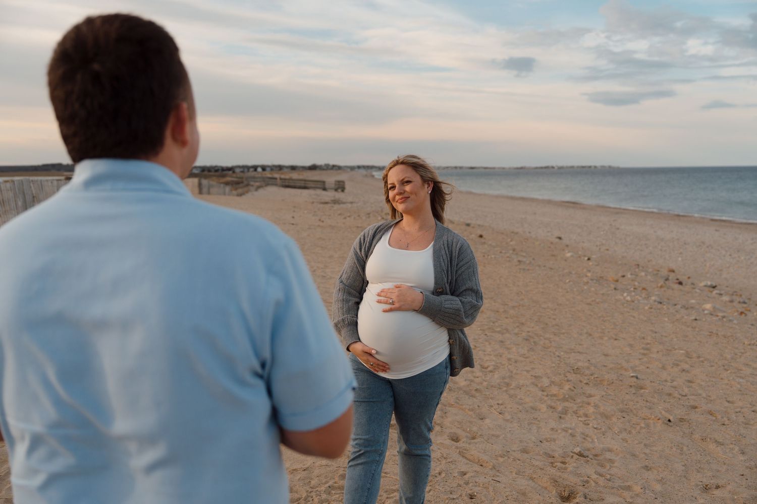 Two people share a joyful moment together on a scenic beach at sunset.