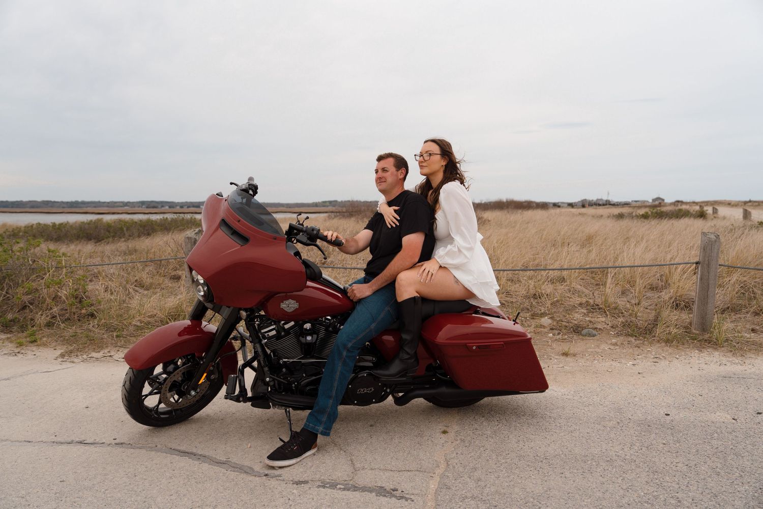 Several photos of a red motorcycle parked in an open field showing different angles and viewpoints.