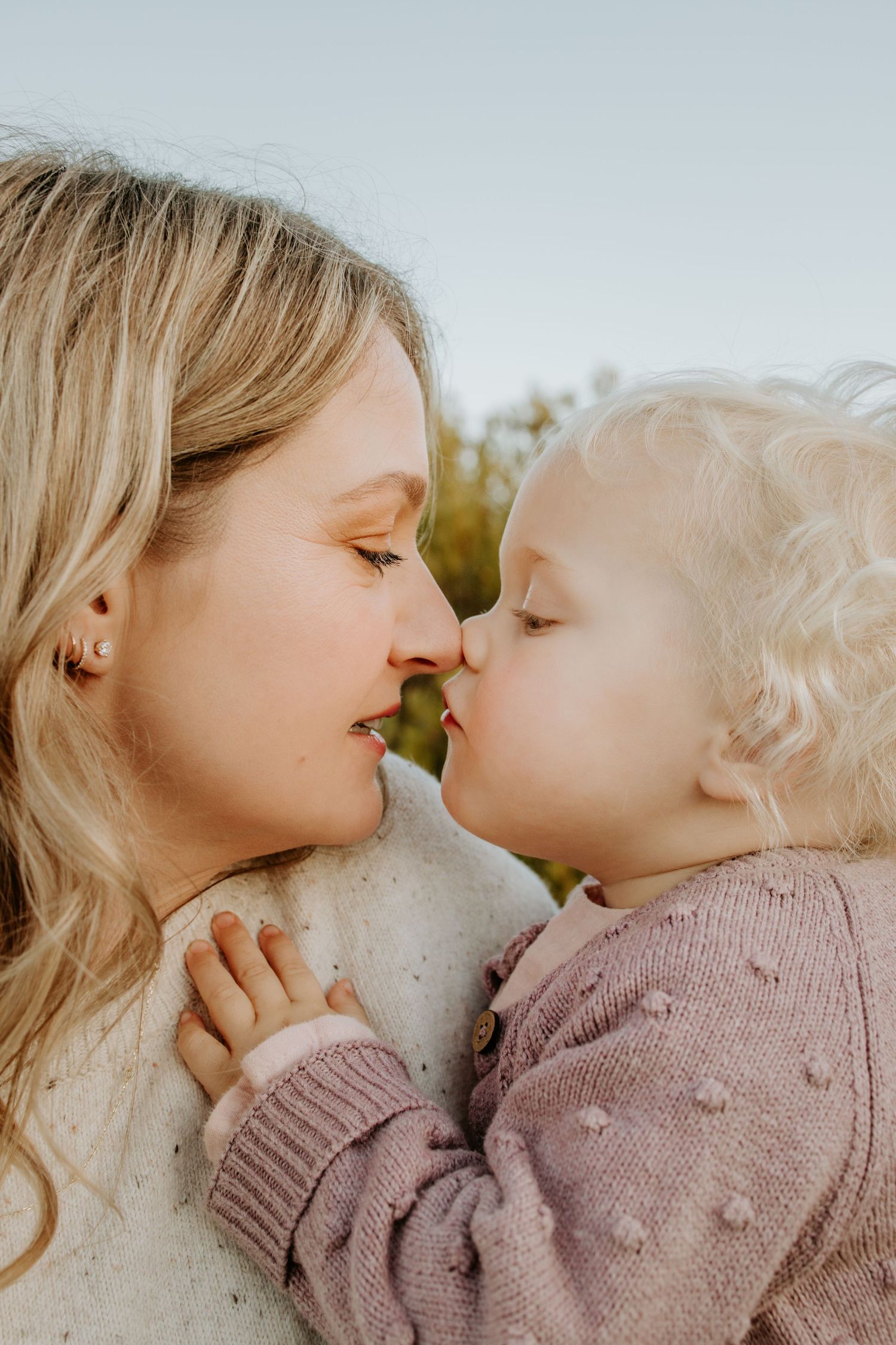 Mother and toddler noses touching at sunset - Adelaide family photography sessions in Maslin Beach, South Australia.