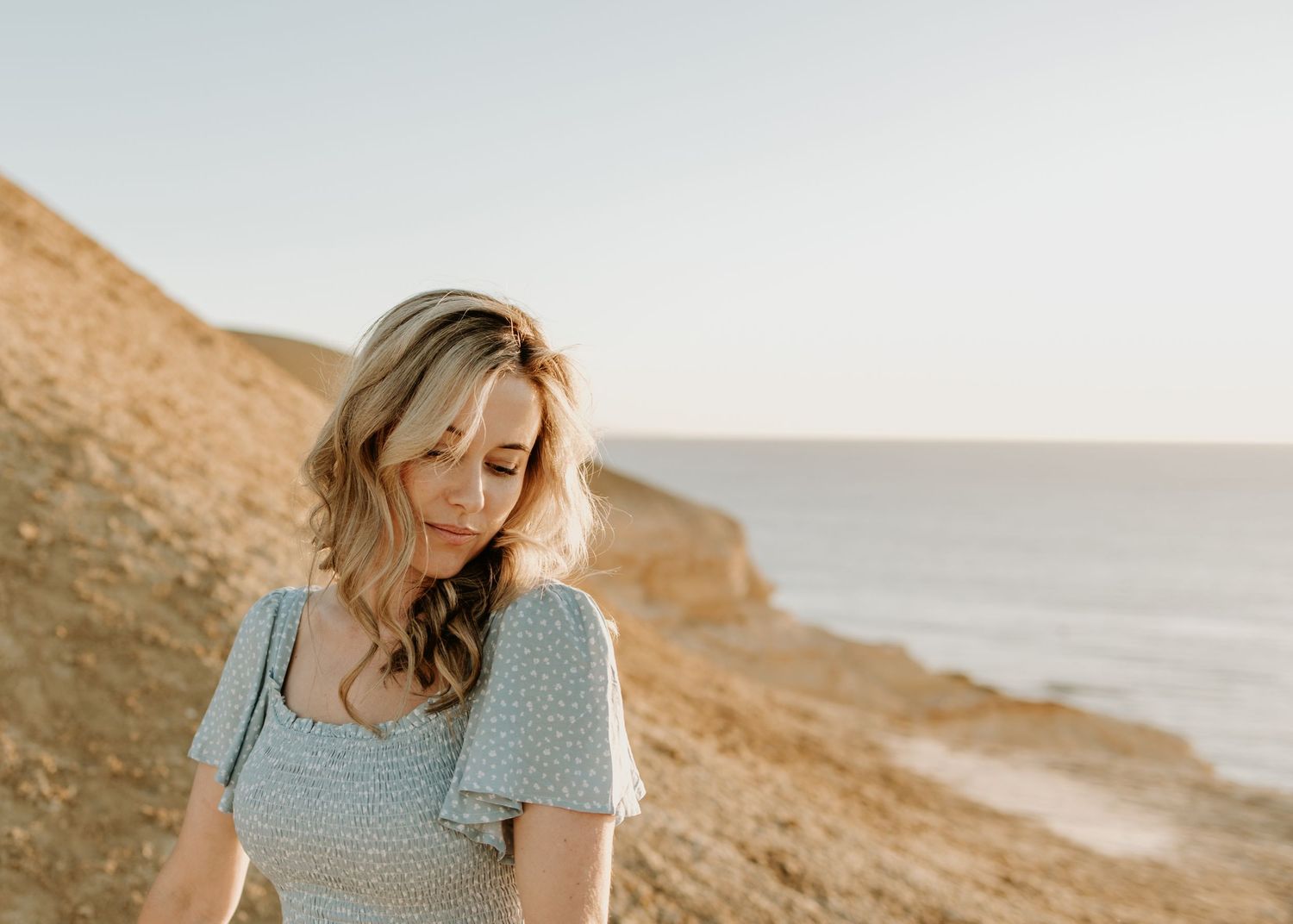 Woman at sunset on beach cliff