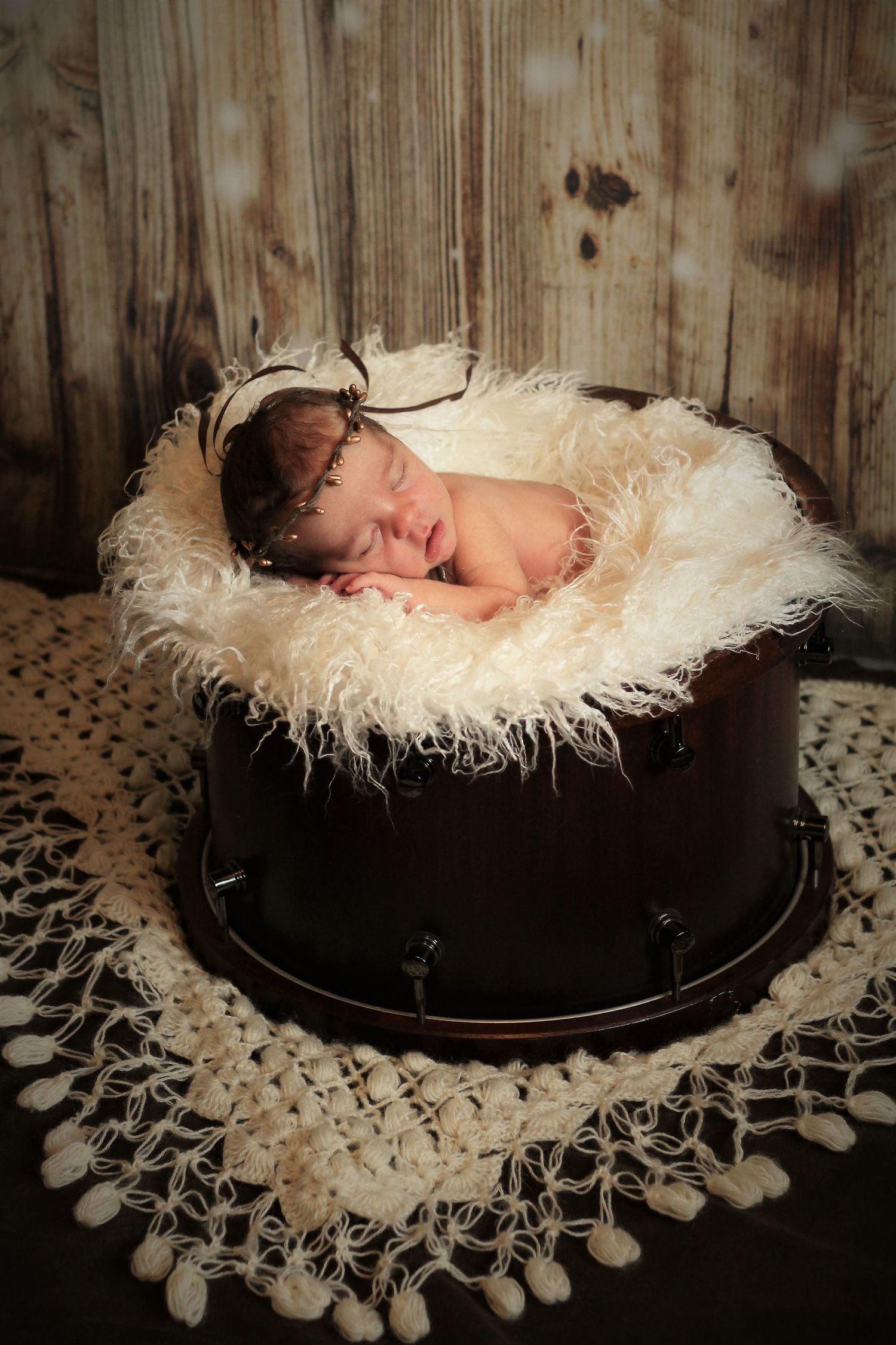 newborn girl asleep in wooden drum styled Newborn Photos