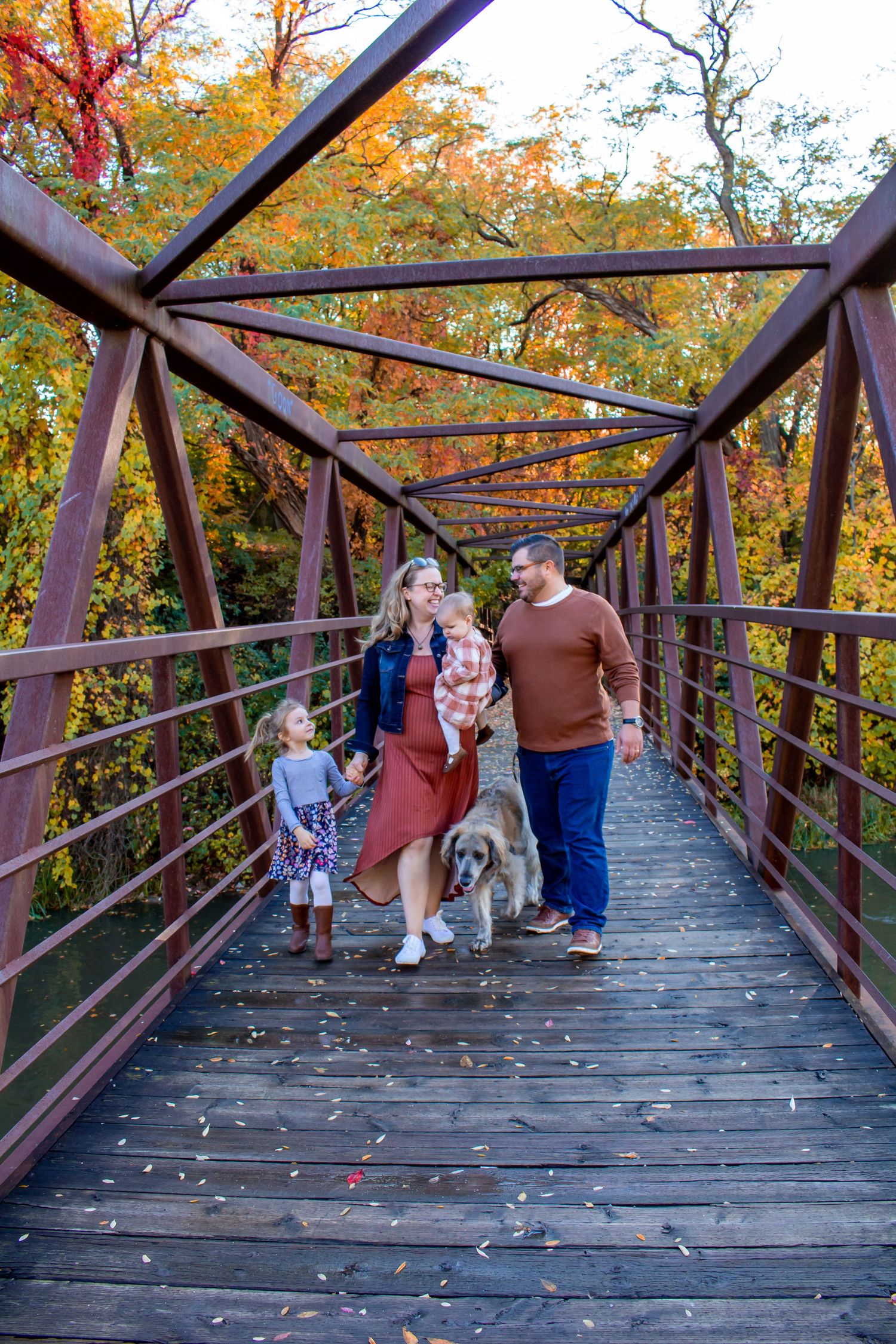 Family of 4 plus dog on a bridge in the fall