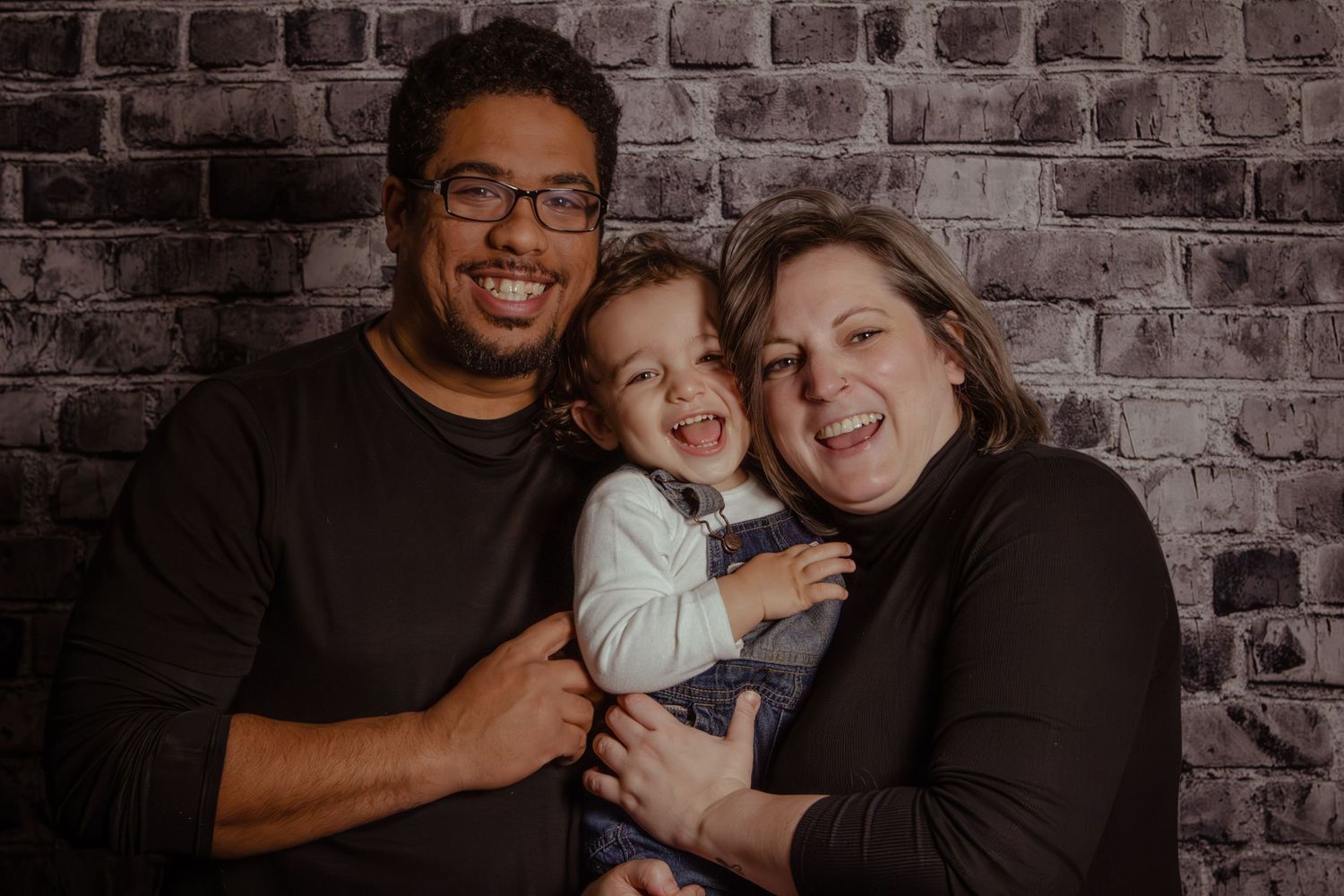 Family photo with toddler laughing
