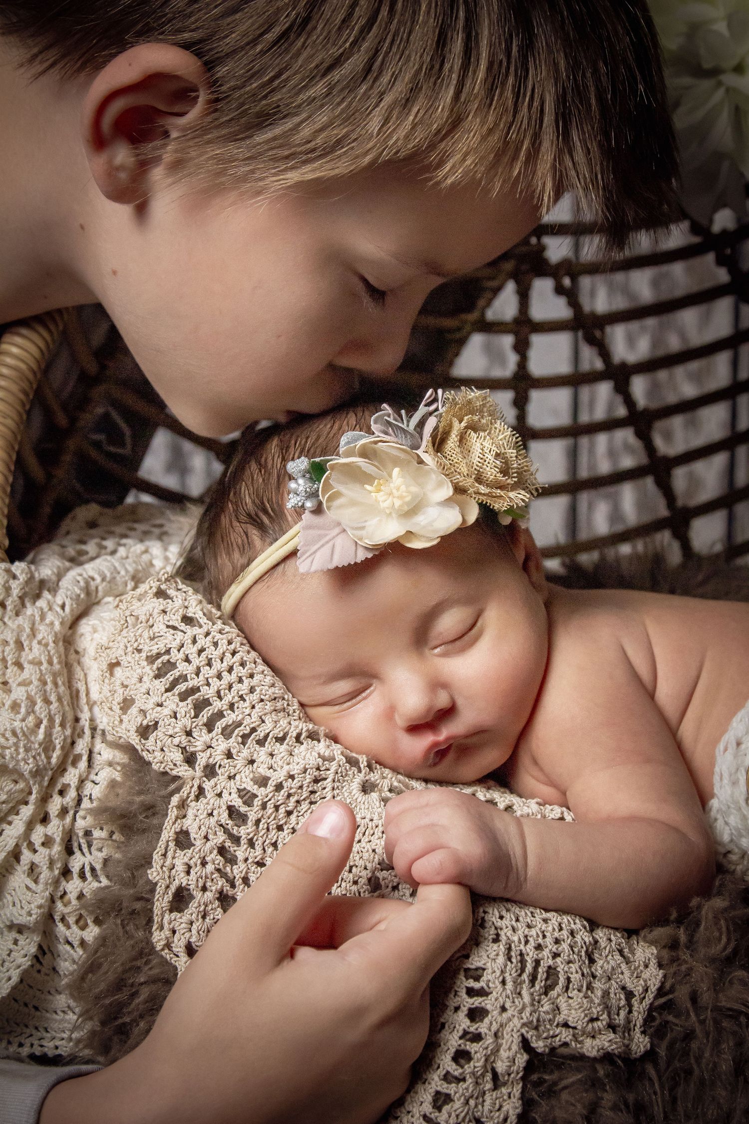 newborn session sleeping baby brother kissing baby sister
