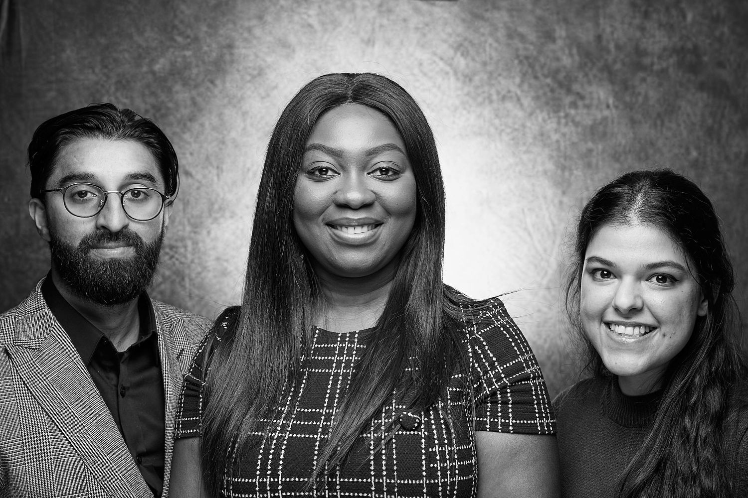 Business group portrait of 3 people with boss in middle. monochrome