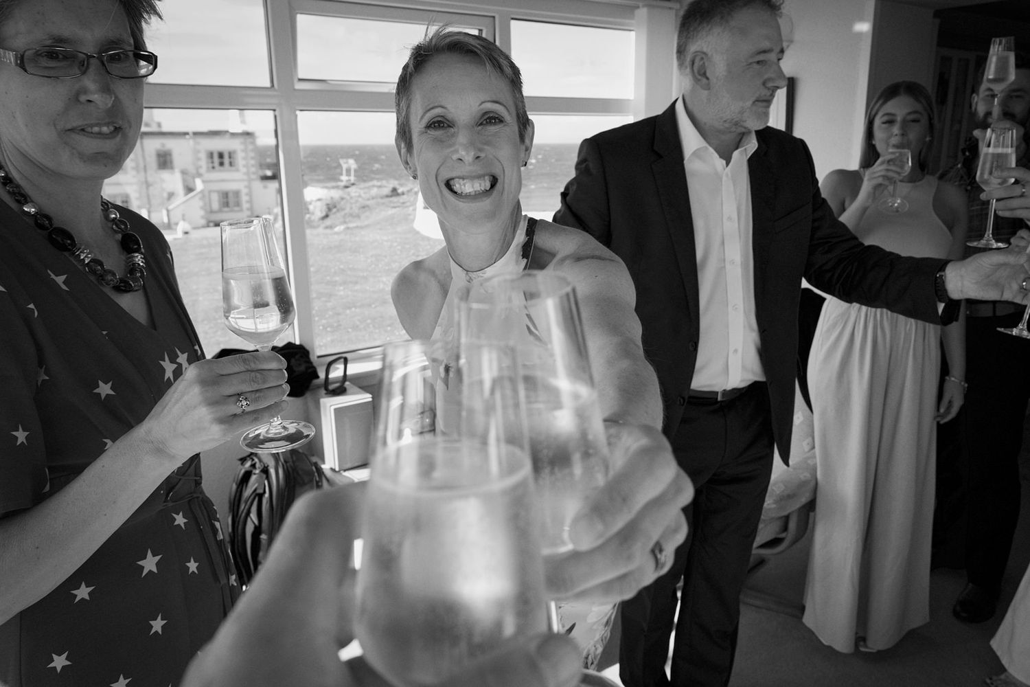 Wedding reception action photo. clinking champagne glasses. monochrome