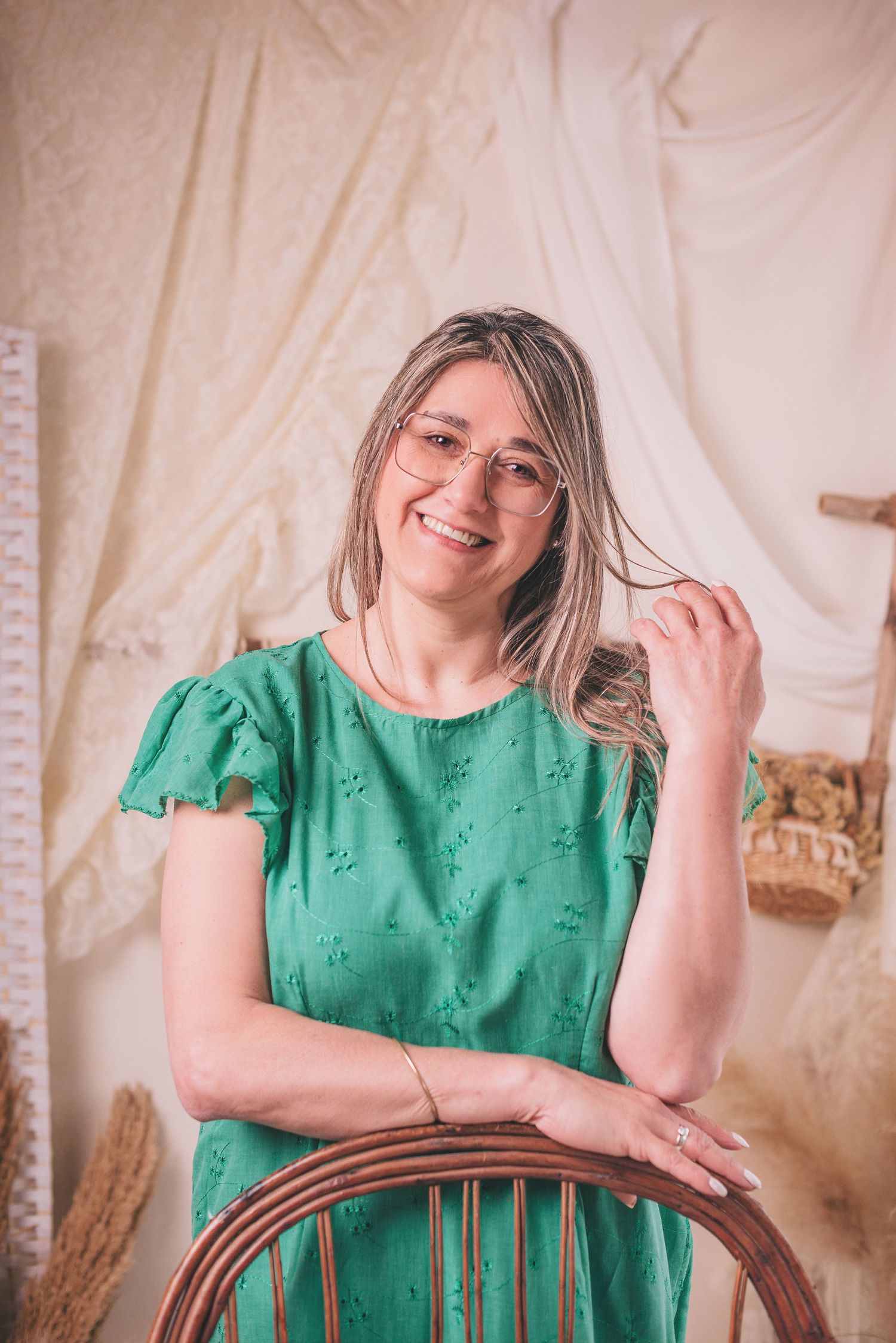 A person in a bright green dress poses against a light-colored backdrop in a series of portrait shots.