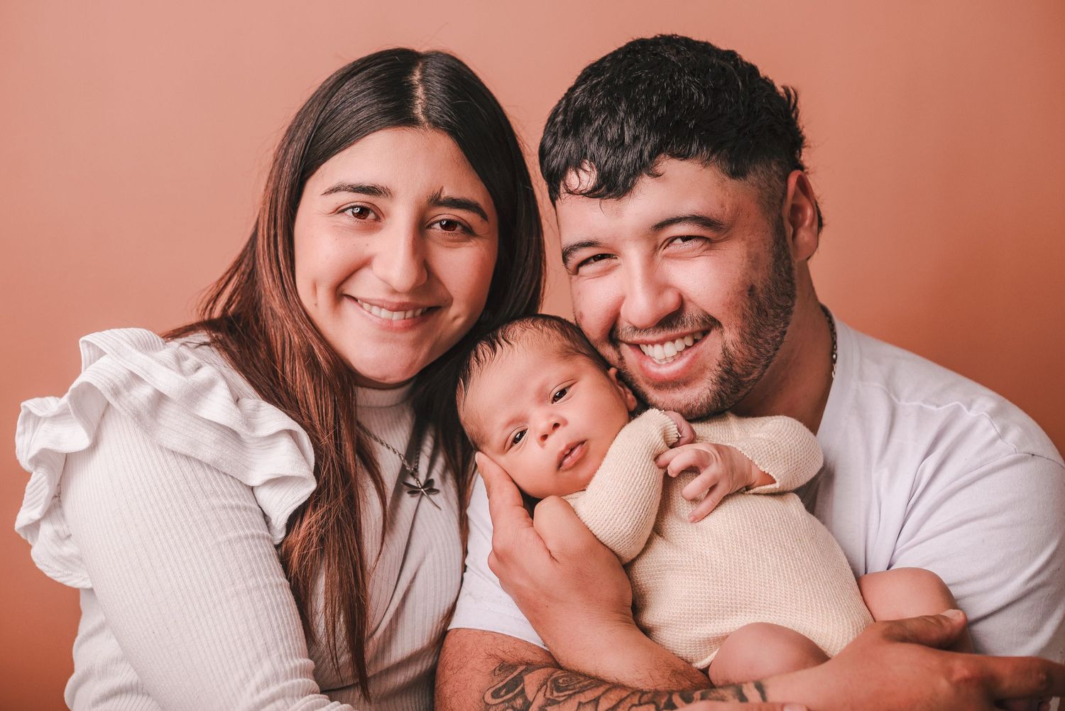 Intimate family portrait session with neutral tones and warm lighting.