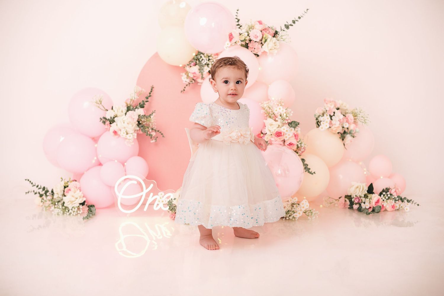 Delicate pink cherry blossoms and floral arrangements create a dreamy spring backdrop with soft lighting and romantic ambiance.