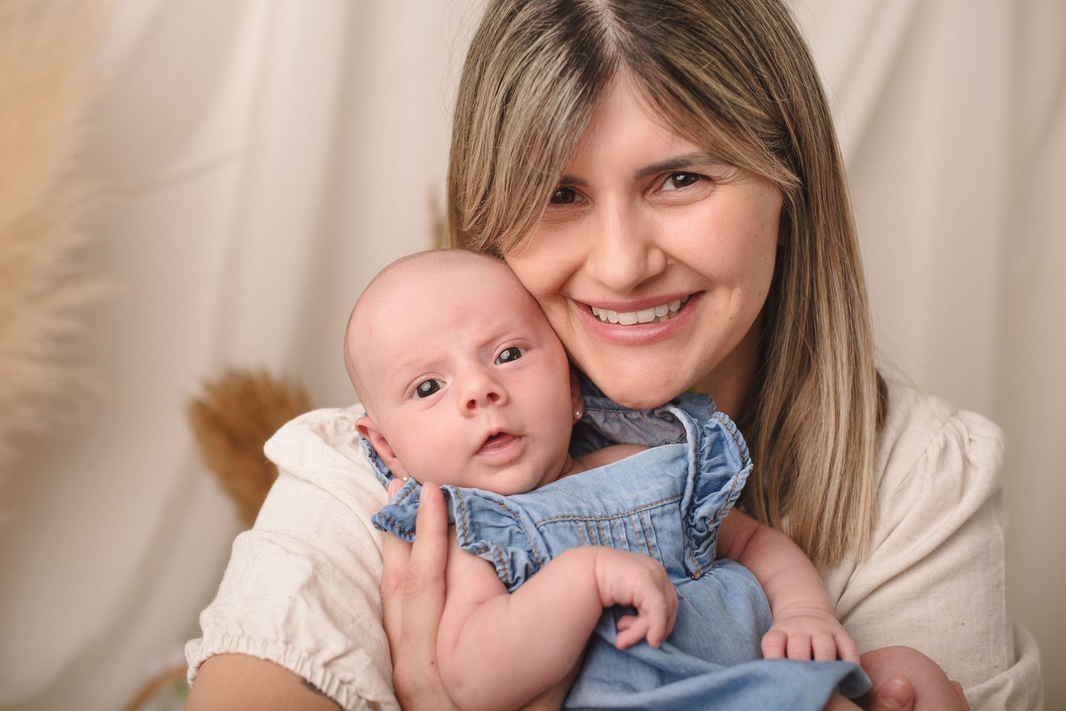 A collage of six photos showing tender moments between a baby and parent in soft natural lighting.