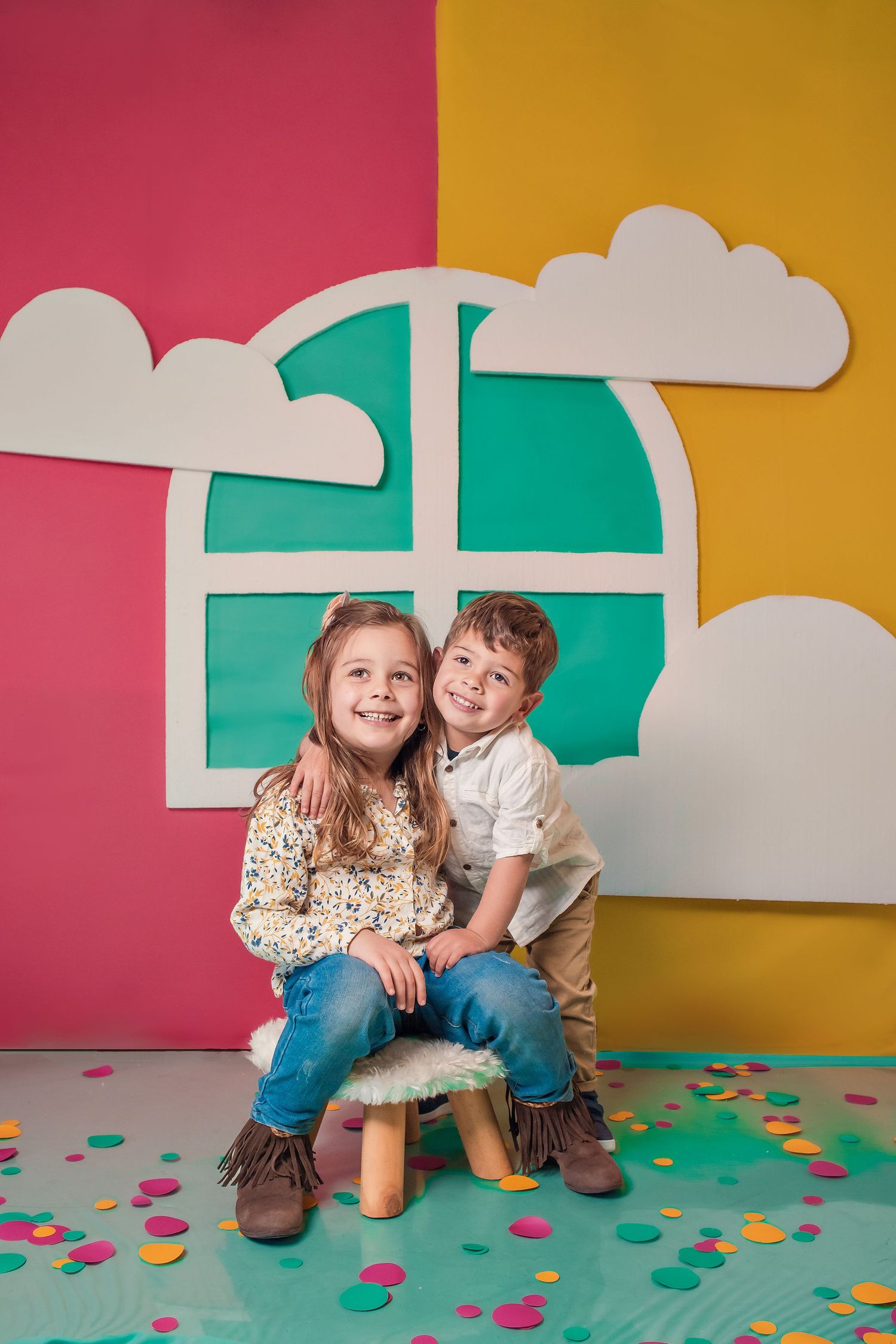 Colorful geometric backdrop with pink, yellow and teal shapes for children's photography.