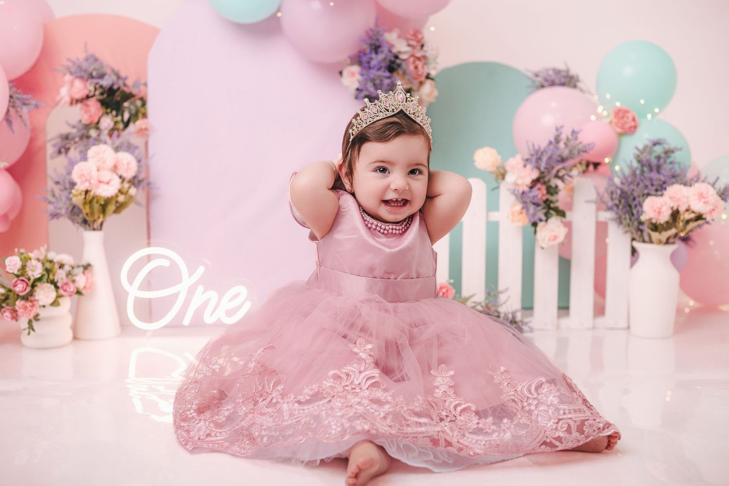 Collage of pink and mint green cake smash photo session with floral decorations and vintage style props.